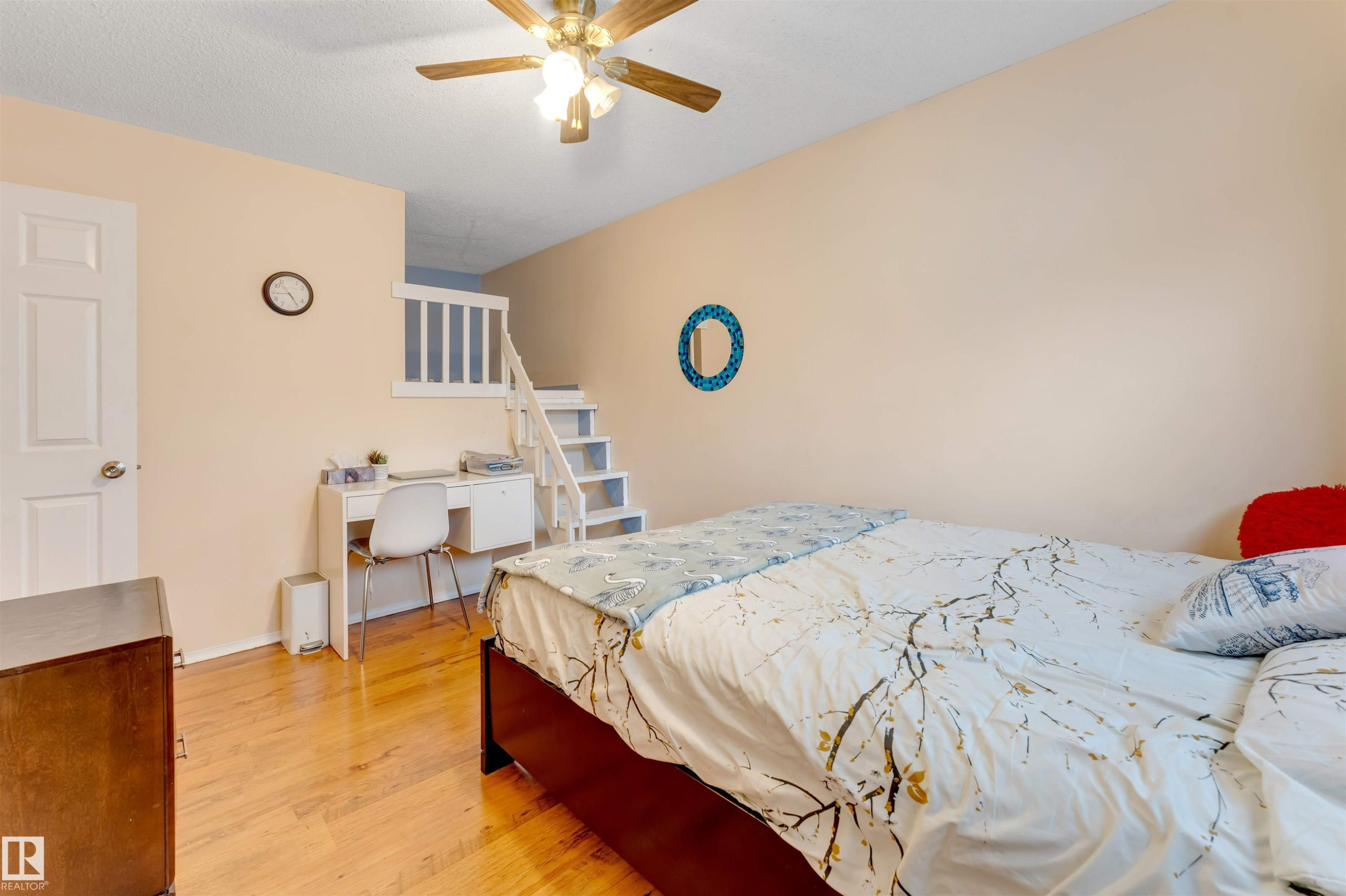 Hardwood-finish flooring throughout, complemented by a light-colored wall palette - 312 Beringer Crescent Nw, Edmonton, AB - Indoor Photo Showing Bedroom