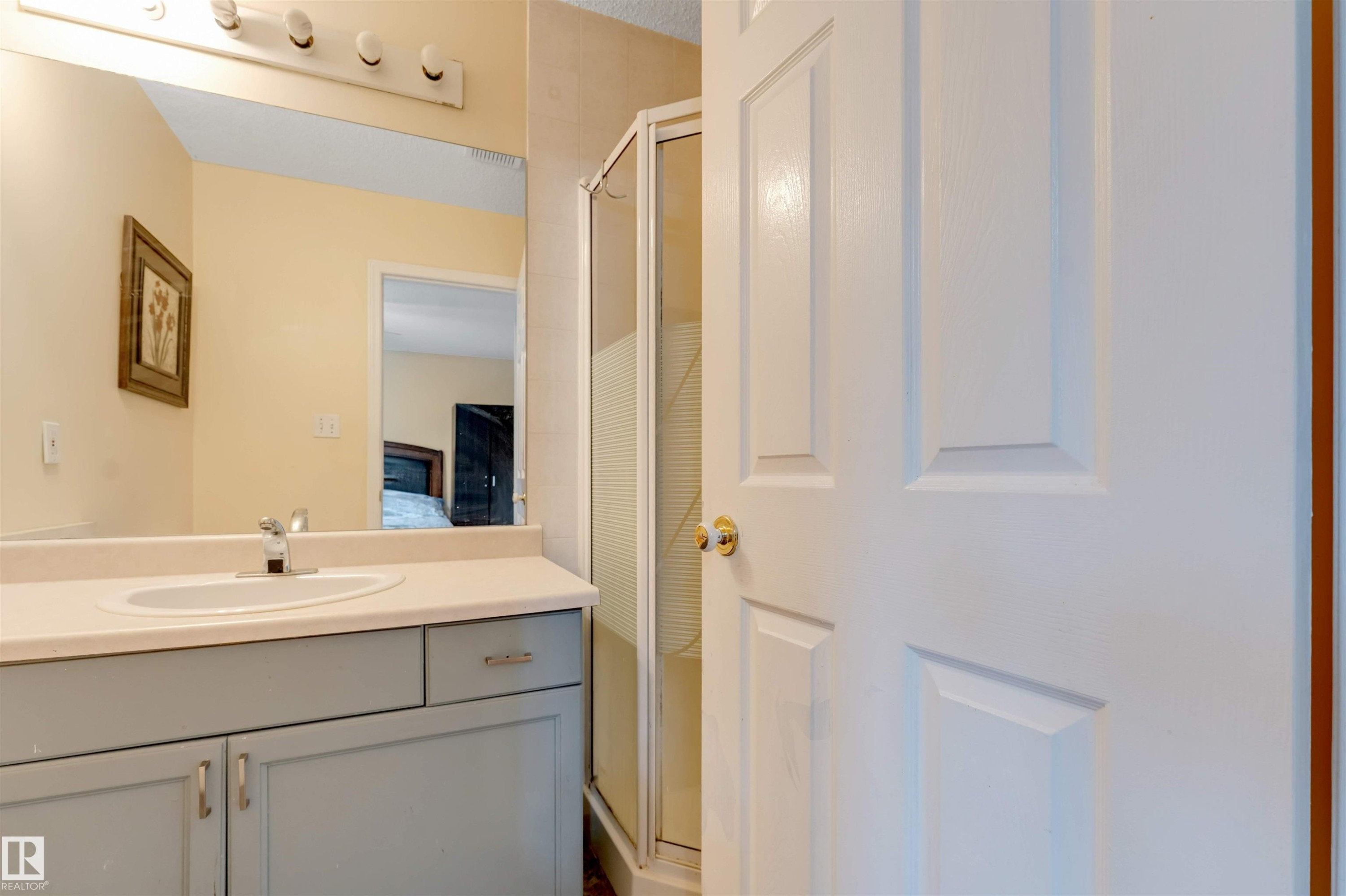 Bathroom vanity with light gray cabinetry, an integrated sink, and a chrome faucet - 312 Beringer Crescent Nw, Edmonton, AB - Indoor Photo Showing Bathroom