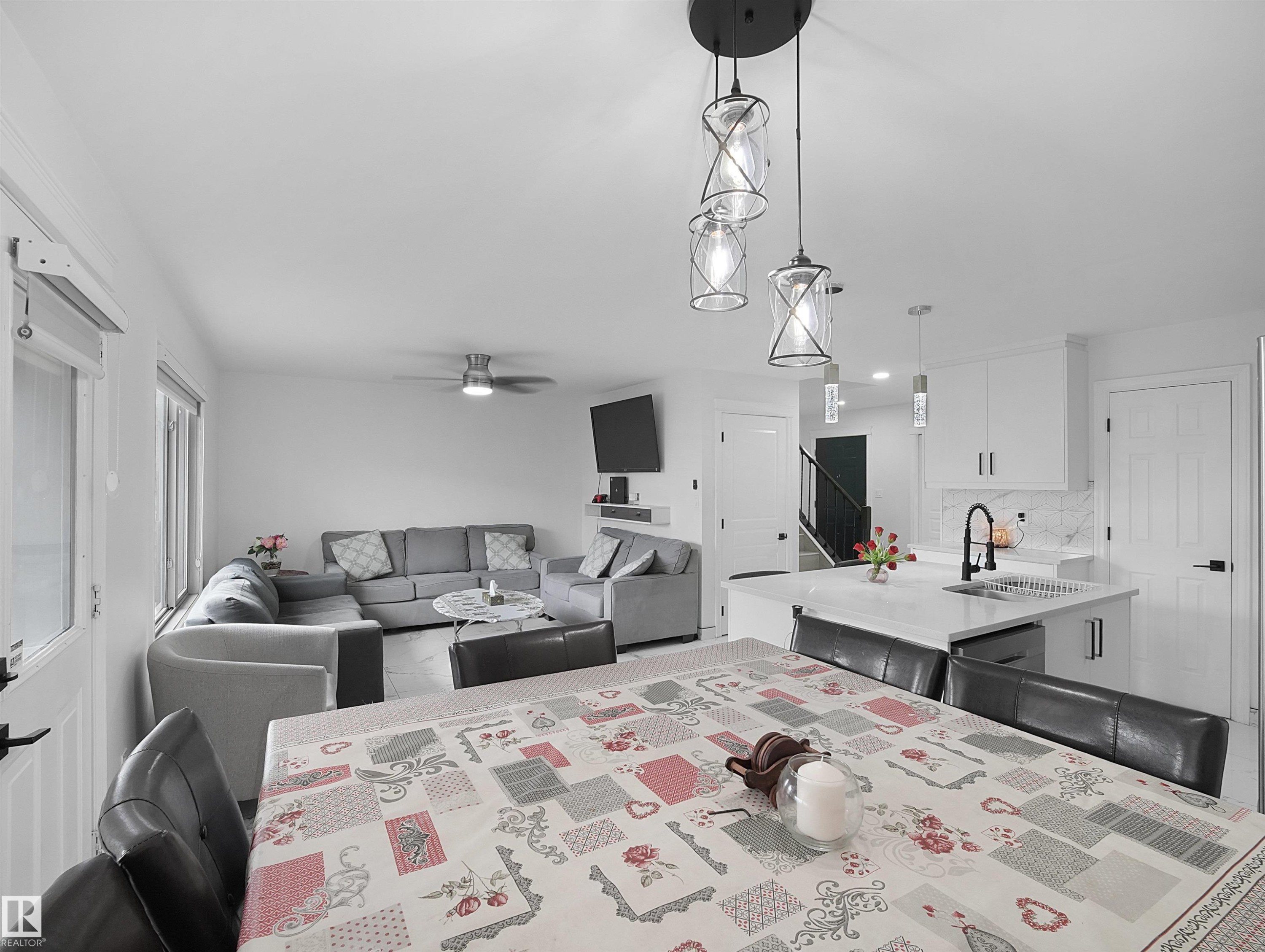Open-concept living area with white walls and wood-finish flooring - 2418 32B Street, Edmonton, AB
