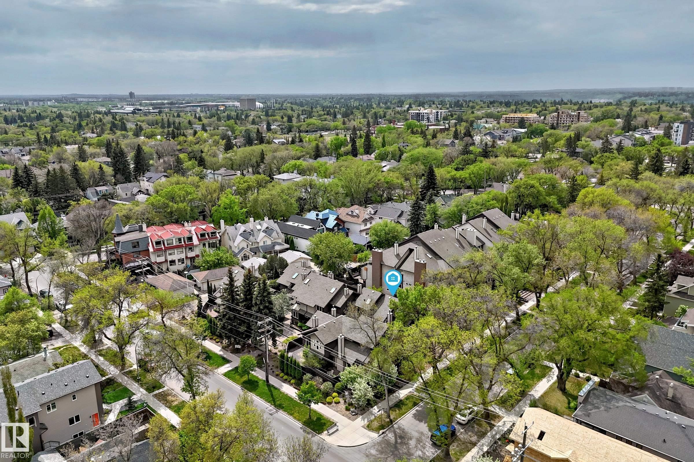 Aerial perspective of a tree-lined residential area featuring multiple housing styles and established greenery - 7930 111 Street, Edmonton, AB - Outdoor With View