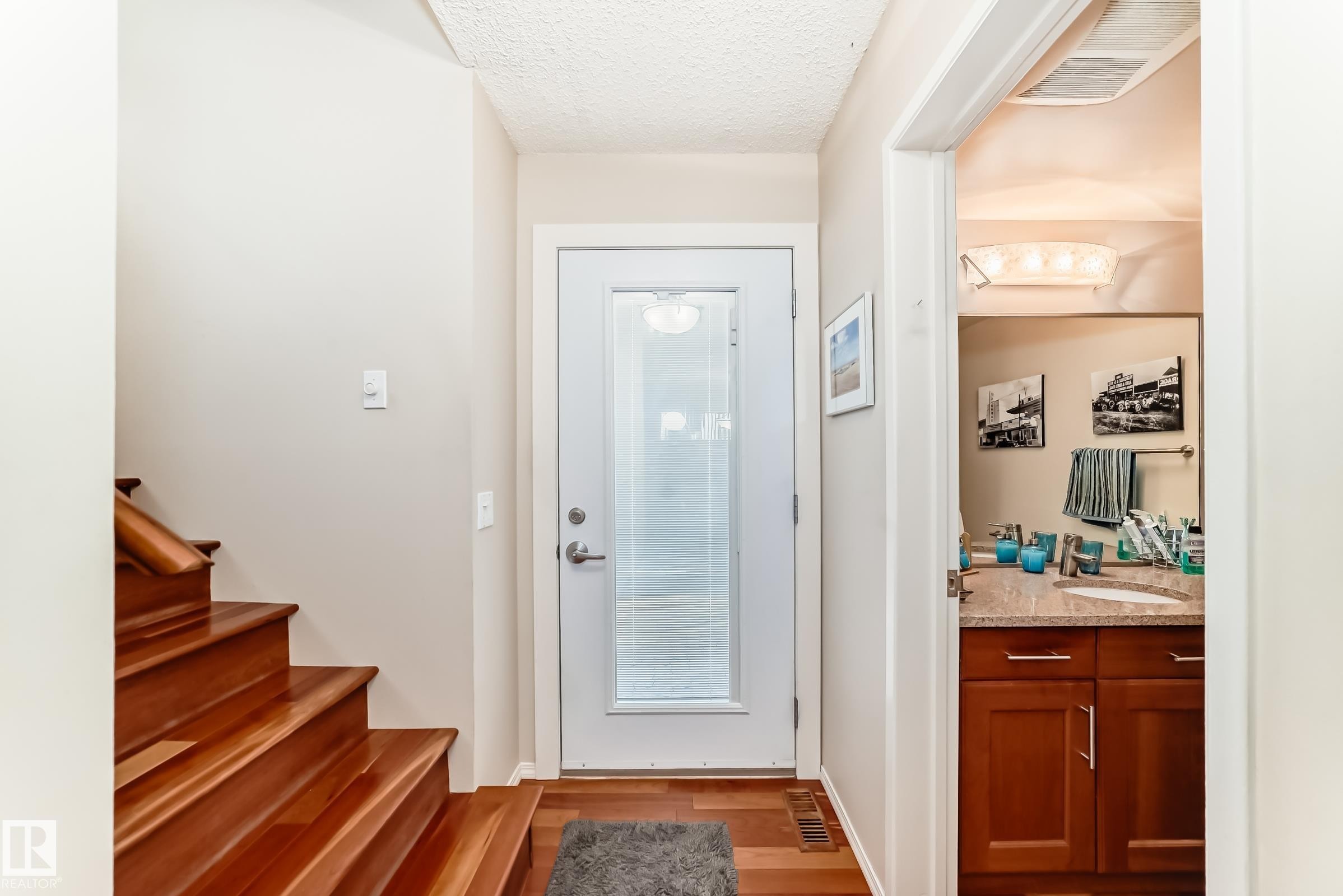 Entryway featuring rich American Cherrywood flooring and a glass-panelled door - 7930 111 Street, Edmonton, AB - Indoor Photo Showing Other Room