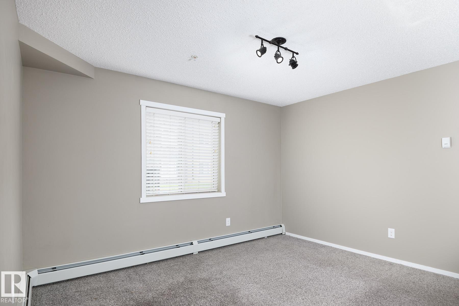 Neutral-toned walls and plush gray carpeting - 102 25 Element Dr, St. Albert, AB