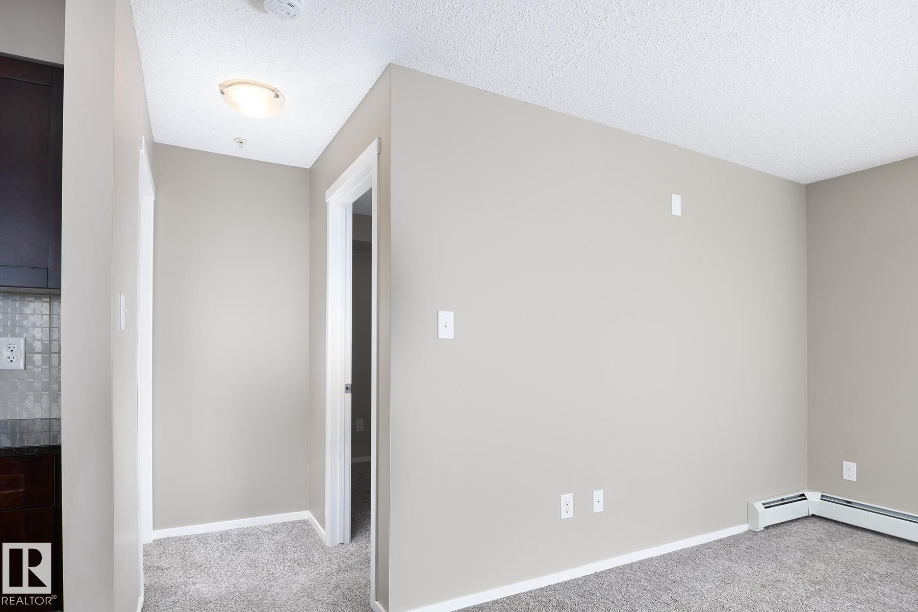 Carpeted flooring throughout, neutral wall paint, and white trim - 102 25 Element Dr, St. Albert, AB
