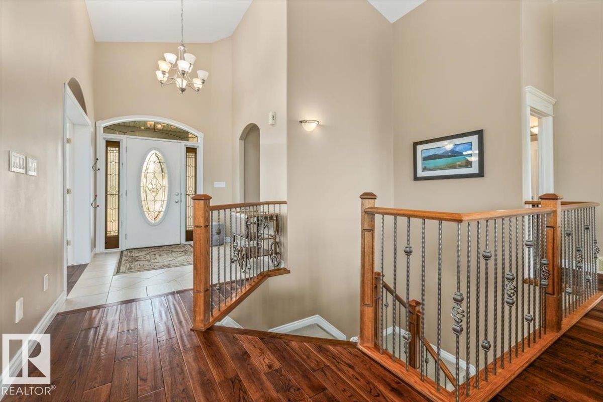 Grand foyer with a vaulted ceiling and a decorative chandelier - 215 Westerra Point(E), Stony Plain, AB