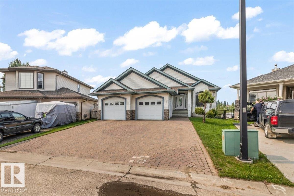 Two-car garage with white paneled doors and decorative windows - 215 Westerra Point(E), Stony Plain, AB