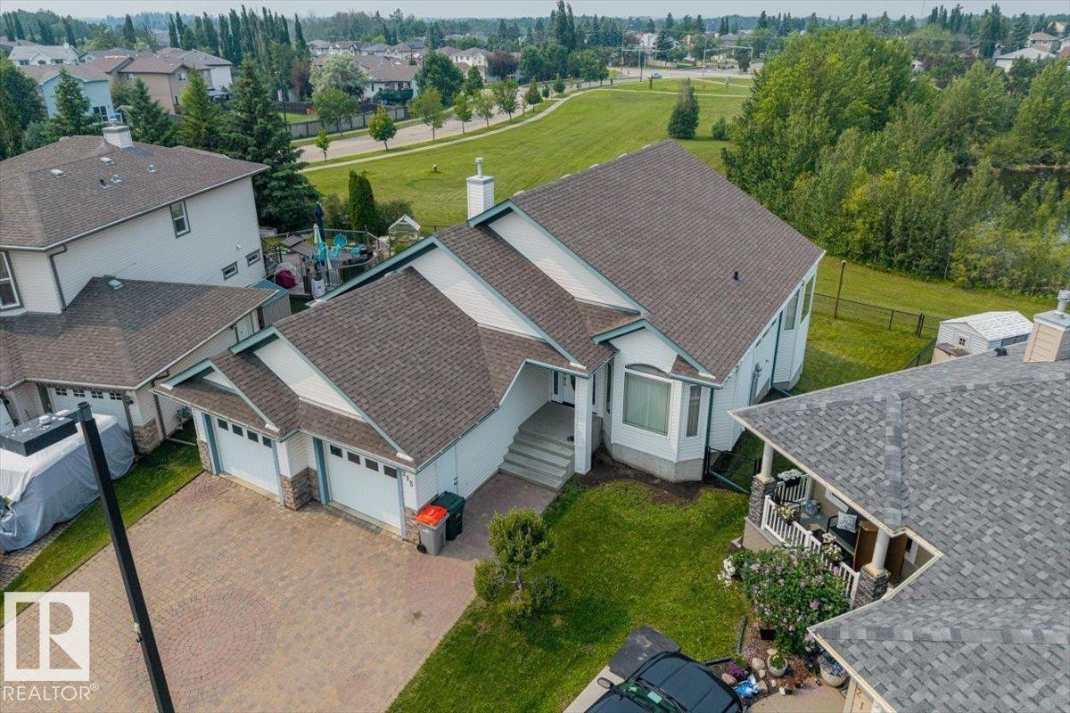 Contemporary residence featuring a multi-gabled roofline and a two-car garage - 215 Westerra Point(E), Stony Plain, AB