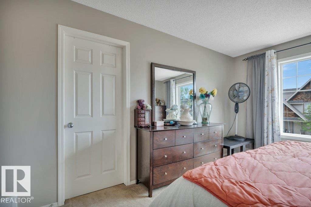 Primary Bedroom with Walk-In Closet and Ensuite - 6042 214 Street, Edmonton, AB - Indoor Photo Showing Bedroom