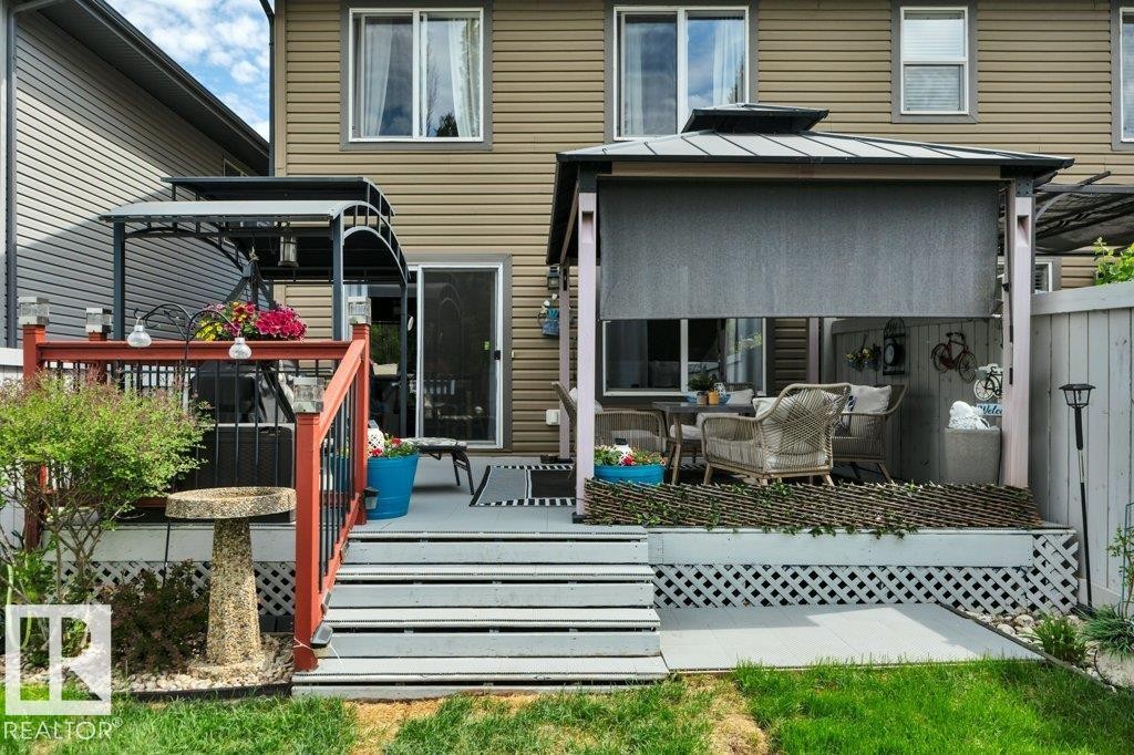 Backyard deck featuring a covered gazebo, privacy screen, and direct access to the interior - 6042 214 Street, Edmonton, AB - Outdoor With Deck Patio Veranda With Exterior