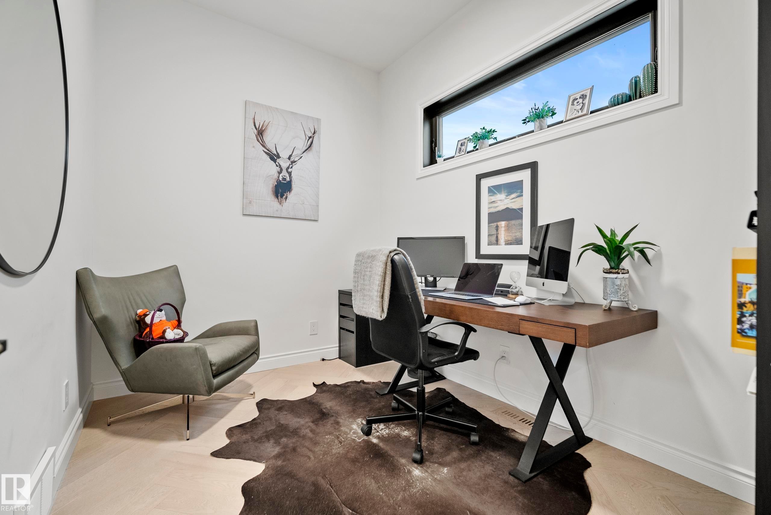 Light wood-finish flooring complements white walls - 6115 111 Avenue, Edmonton, AB - Indoor Photo Showing Office