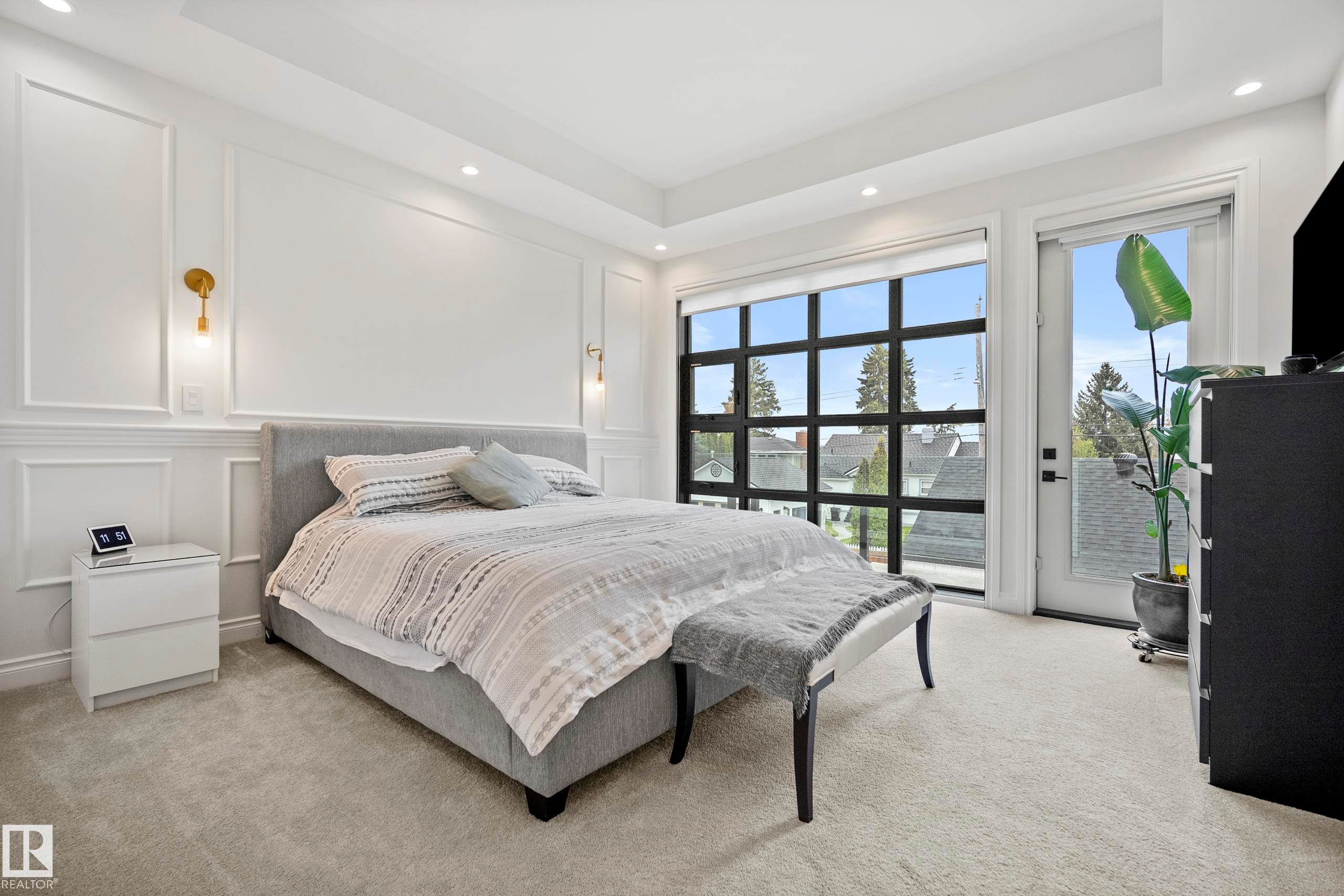 Bedroom featuring a large grid-pane window and a white door with a glass panel - 6115 111 Avenue, Edmonton, AB - Indoor Photo Showing Bedroom