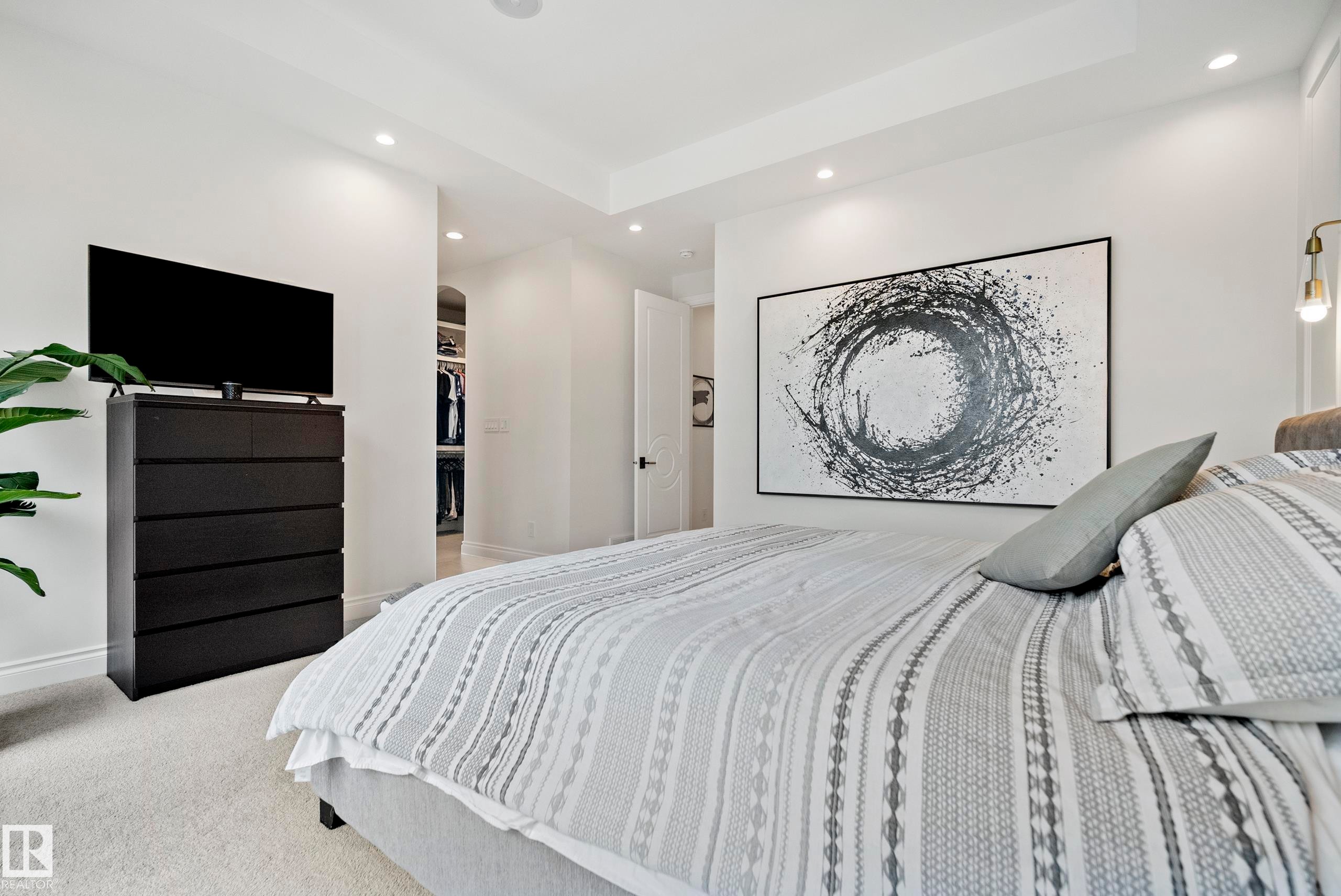 Recessed lighting illuminating a spacious room with light-toned carpeting and a wide doorway revealing a built-in closet system - 6115 111 Avenue, Edmonton, AB - Indoor Photo Showing Bedroom