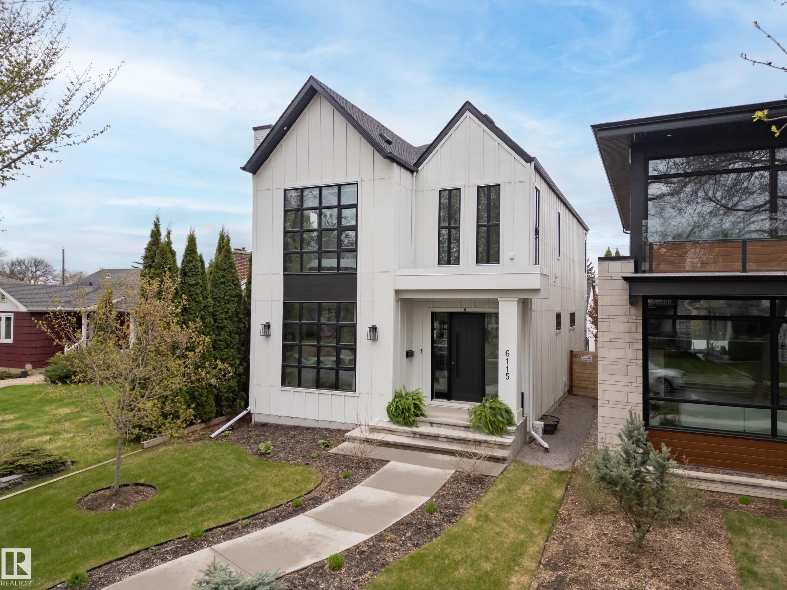 Modern farmhouse architecture with vertical white siding and black trim - 6115 111 Avenue, Edmonton, AB - Outdoor With Facade
