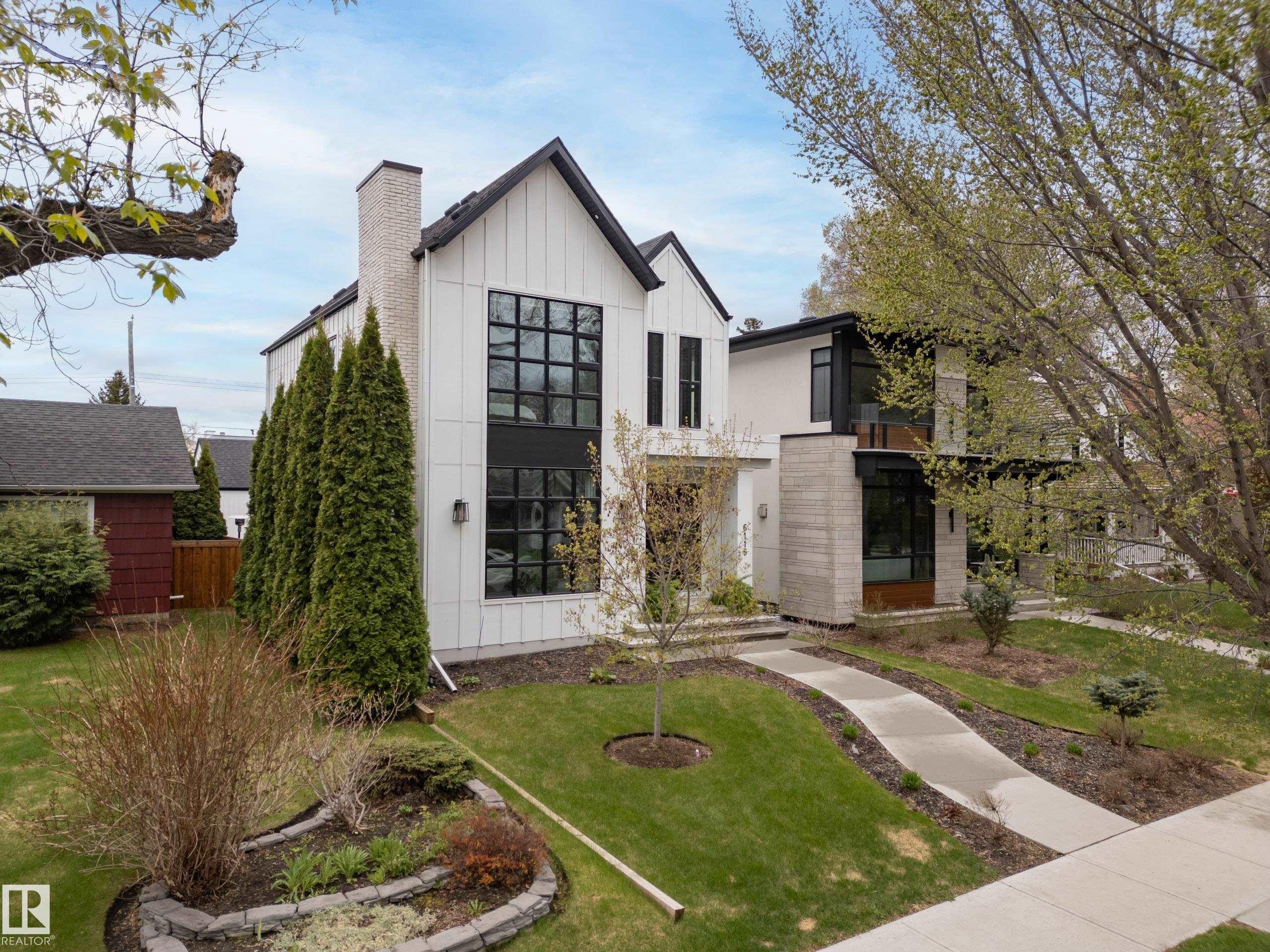 Modern architectural style featuring white vertical siding and black-framed windows - 6115 111 Avenue, Edmonton, AB - Outdoor
