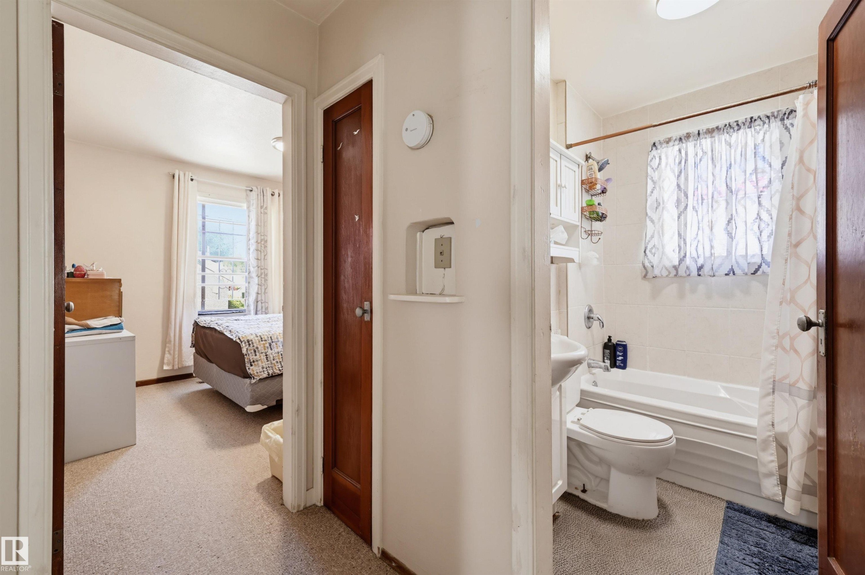 Bedroom with a carpeted floor and a window providing natural light - 11414 88 Street Nw, Edmonton, AB