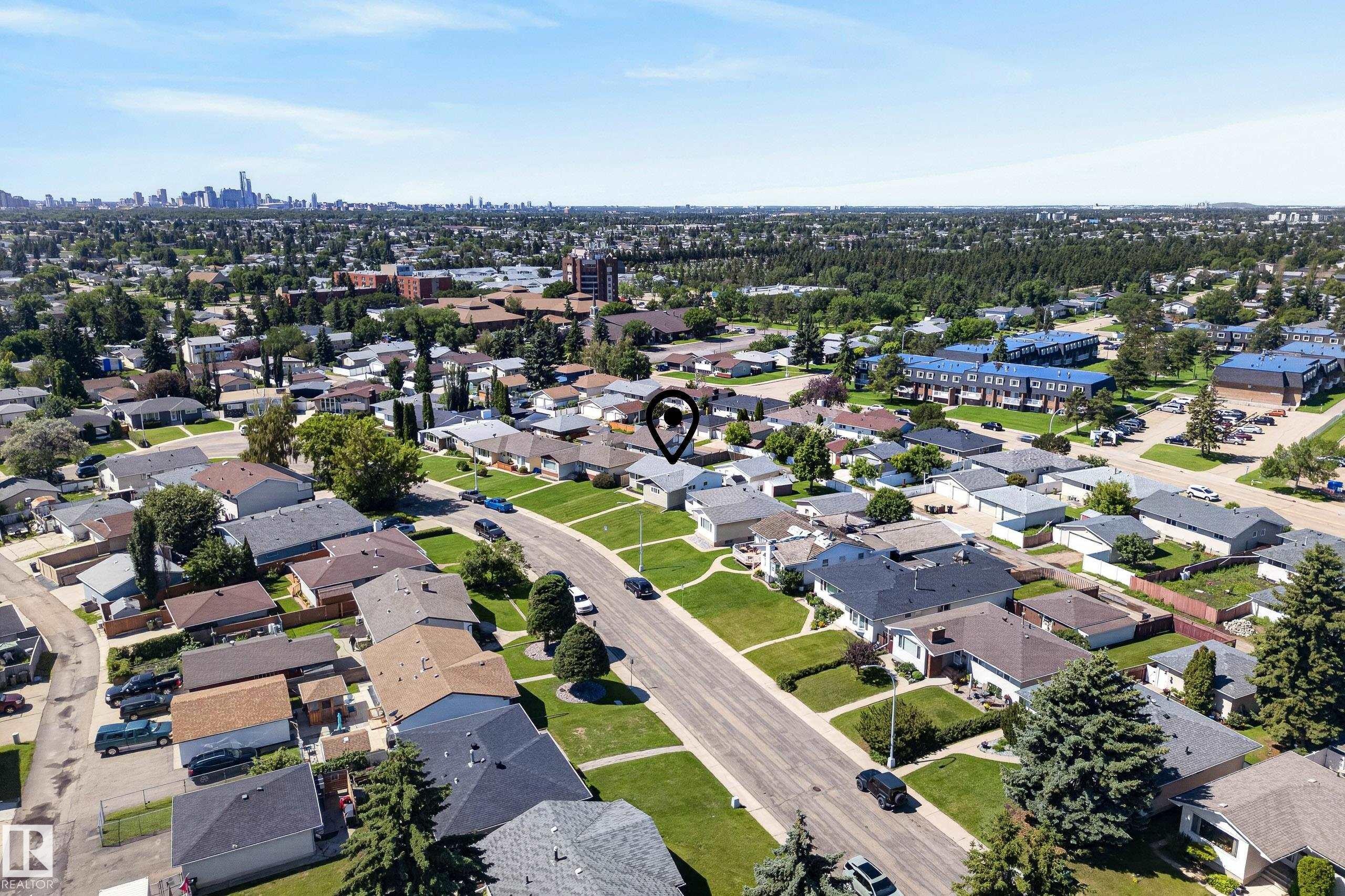 Aerial perspective showcasing a residential neighborhood with a distant cityscape - 14128 73 Street, Edmonton, AB