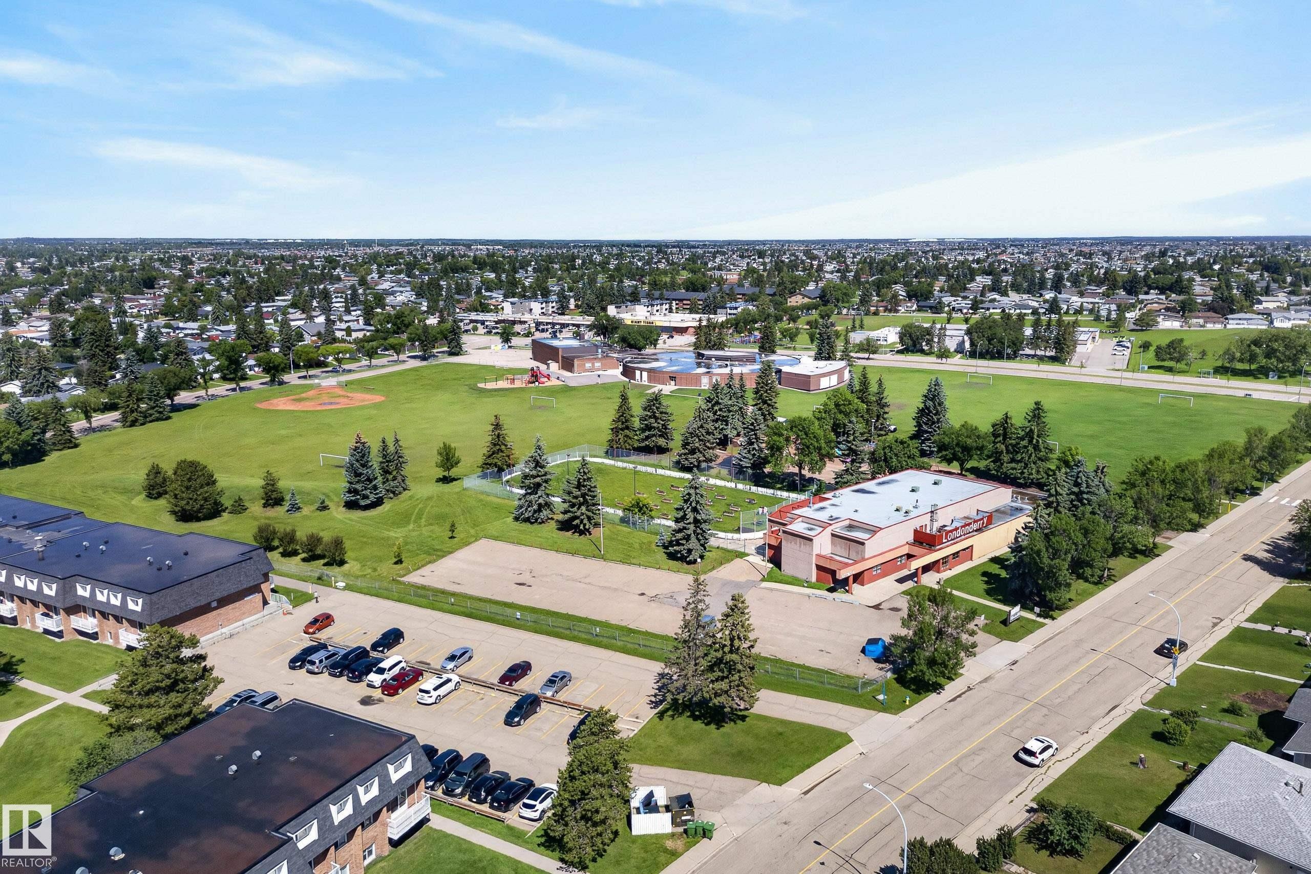 Aerial perspective showcasing a residential neighborhood with ample green space - 14128 73 Street, Edmonton, AB