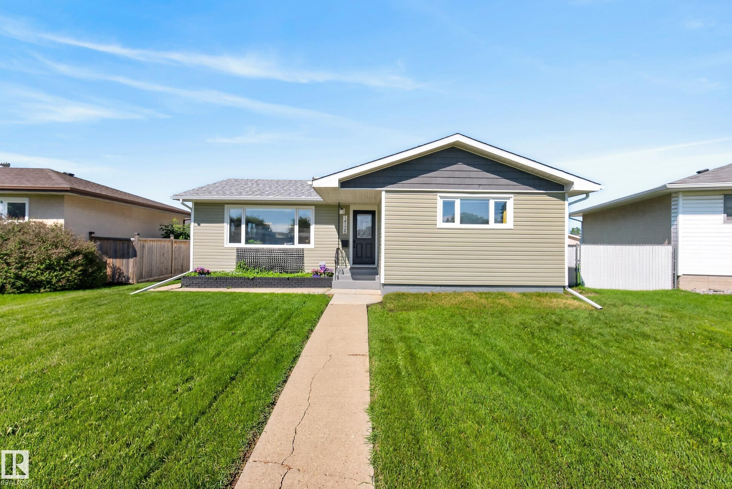 Single-story residence featuring light green siding and a contrasting dark gray gable - 14128 73 Street, Edmonton, AB