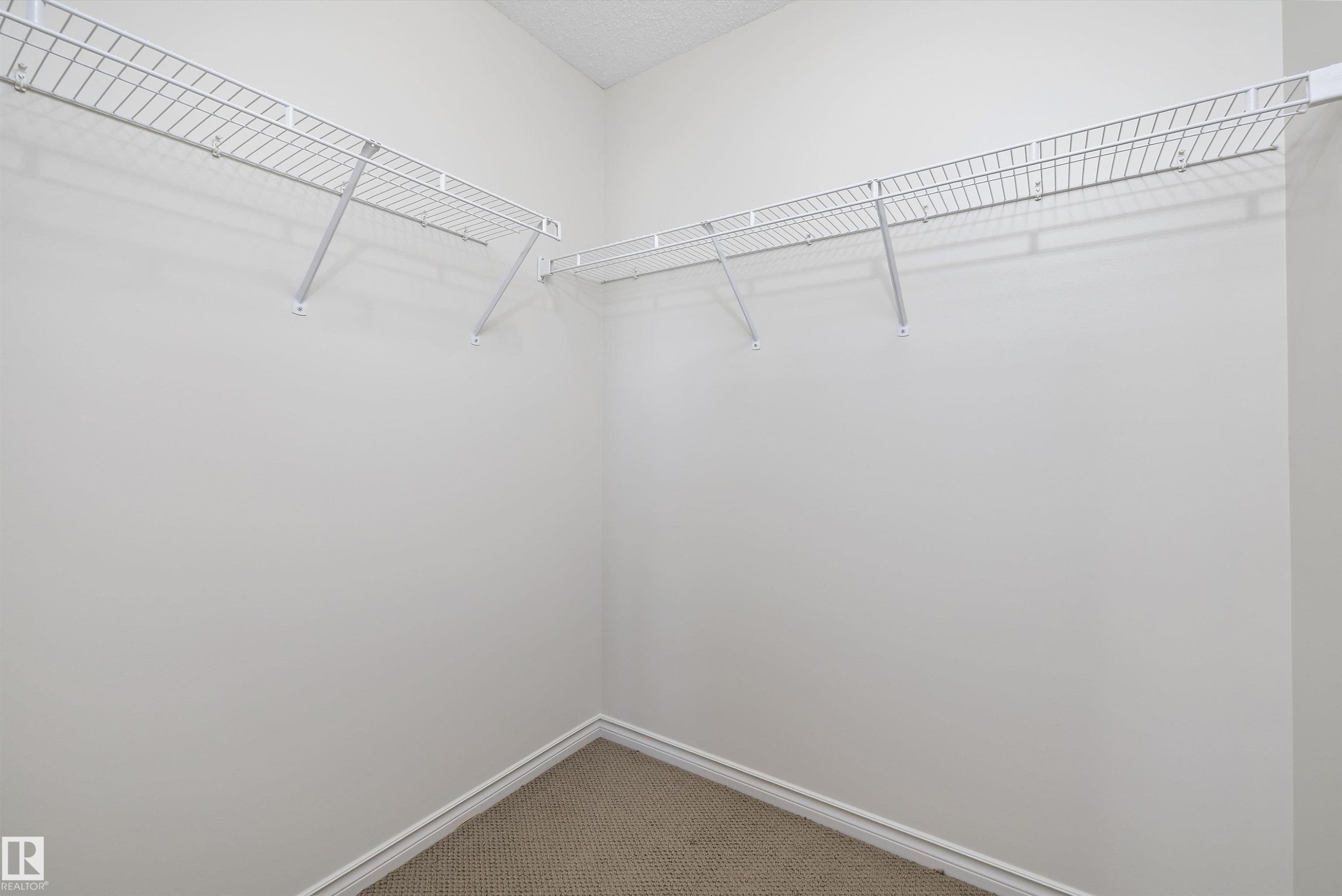 Corner closet featuring wire shelving - 101 13825 155 Avenue, Edmonton, AB