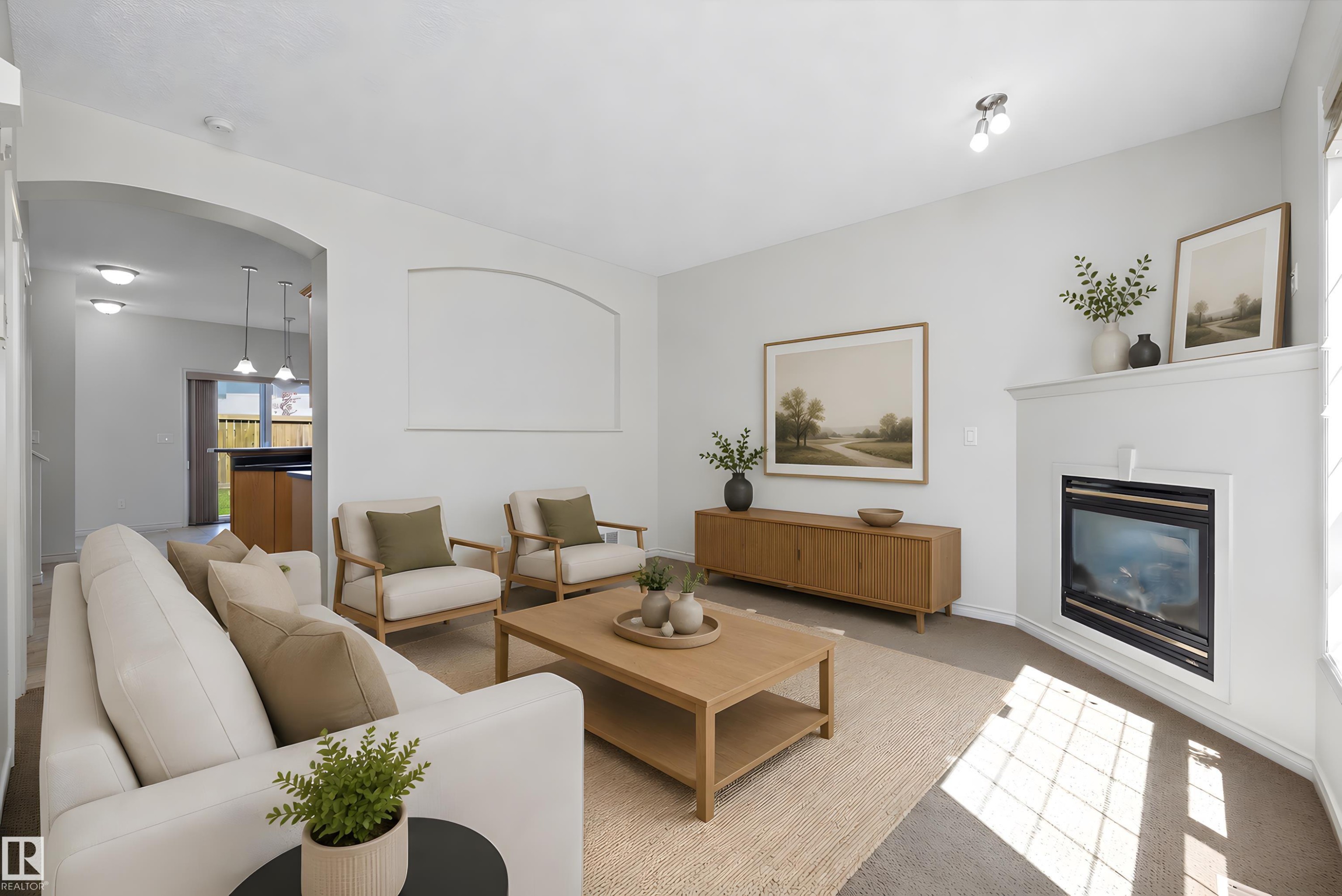 Living room featuring a built-in fireplace with a white mantel, light-colored carpeting, an arched doorway, and recessed ceiling lights - 101 13825 155 Avenue, Edmonton, AB