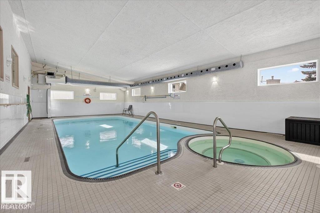 Indoor swimming pool featuring a connected hot tub - 219 Knottwood Road, Edmonton, AB