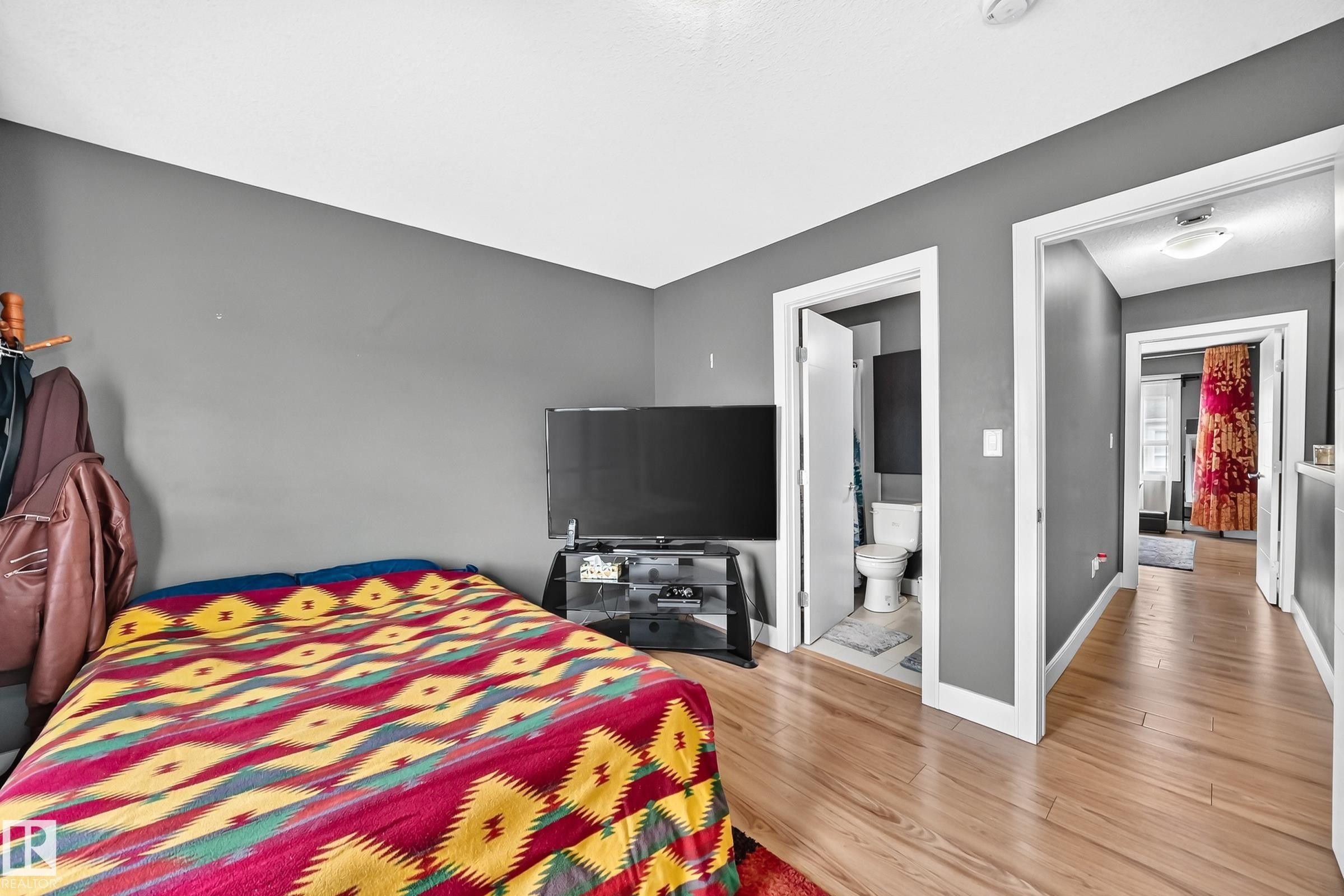 Light wood-finish flooring extending through the space - 37 13003 132 Avenue Nw, Edmonton, AB