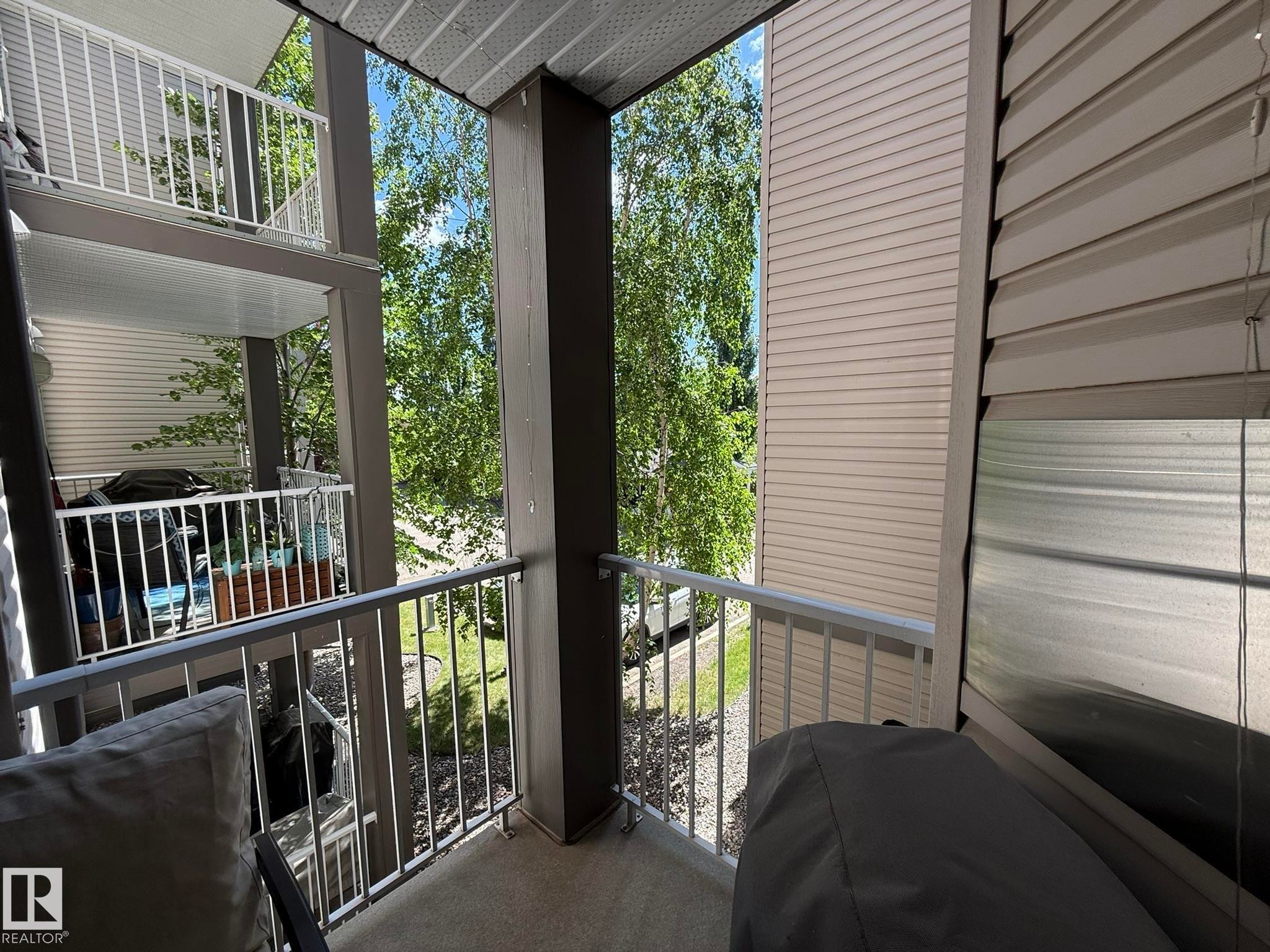 Private outdoor balcony space with concrete flooring and metal railings - 205 3425 19 Street, Edmonton, AB