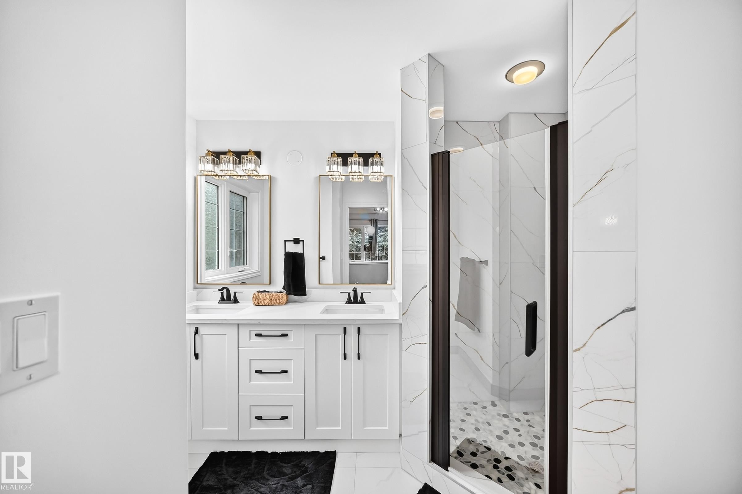 Modern bathroom featuring a dual vanity with white shaker-style cabinetry, dark hardware, and undermount sinks - 10323 138 Street Nw, Edmonton, AB - Indoor Photo Showing Bathroom