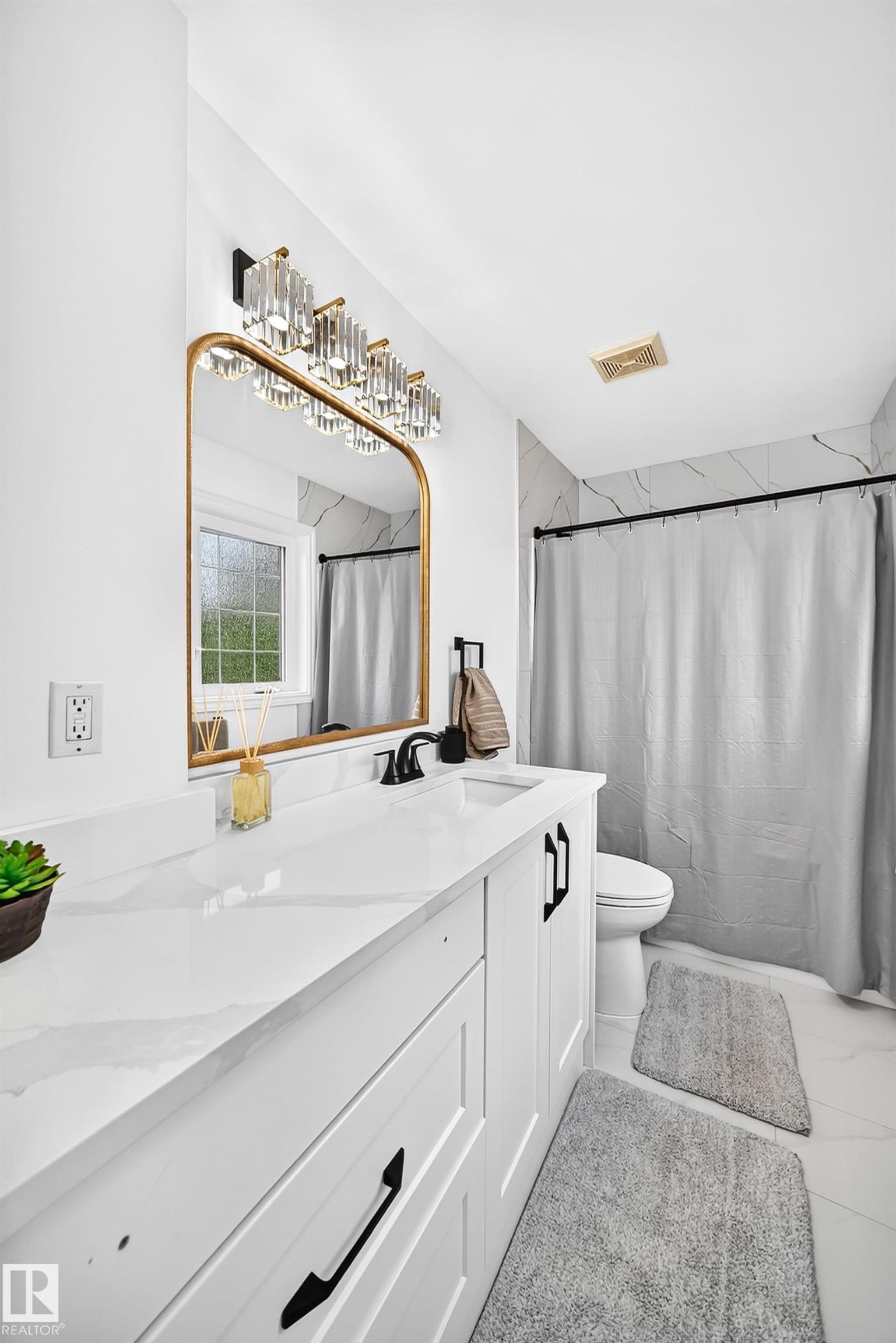 Bathroom featuring a white vanity with panel cabinetry and black hardware - 10323 138 Street Nw, Edmonton, AB - Indoor Photo Showing Bathroom