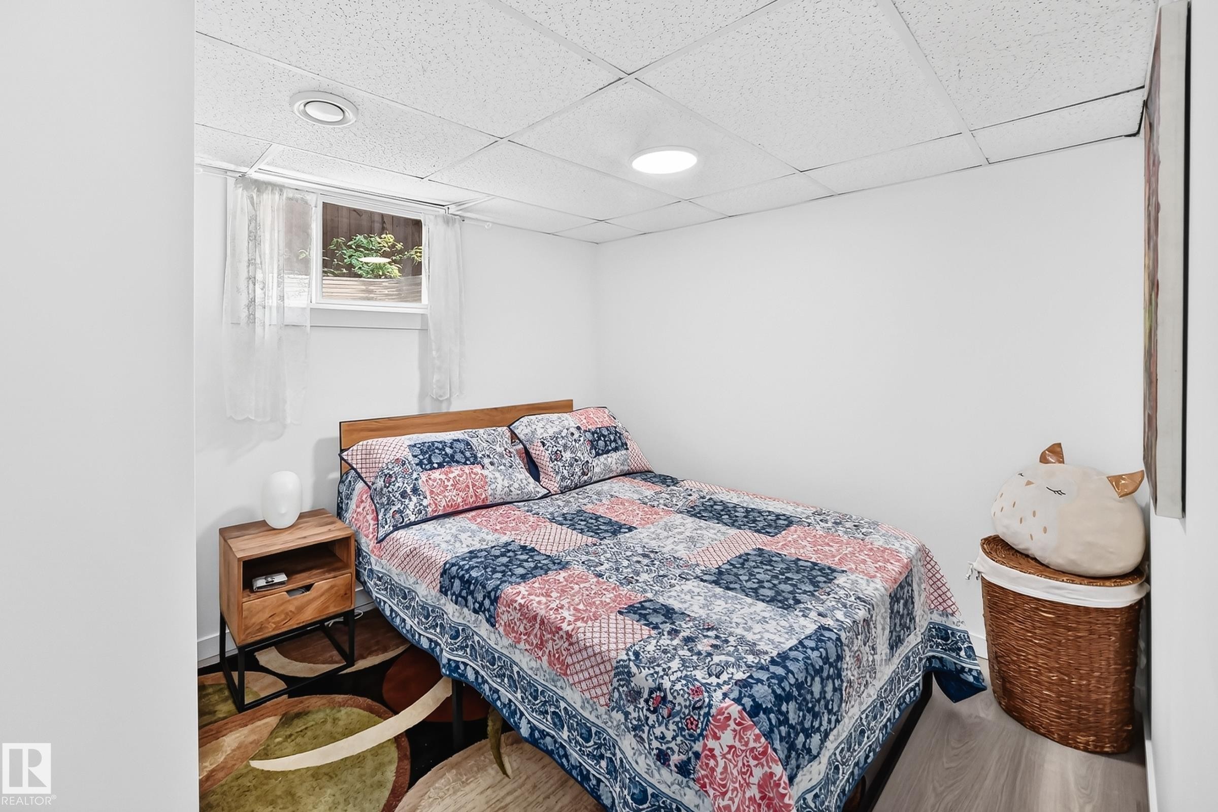 Bedroom featuring a window, textured ceiling tiles, recessed lighting, and wood-finish flooring - 10323 138 Street Nw, Edmonton, AB - Indoor Photo Showing Bedroom