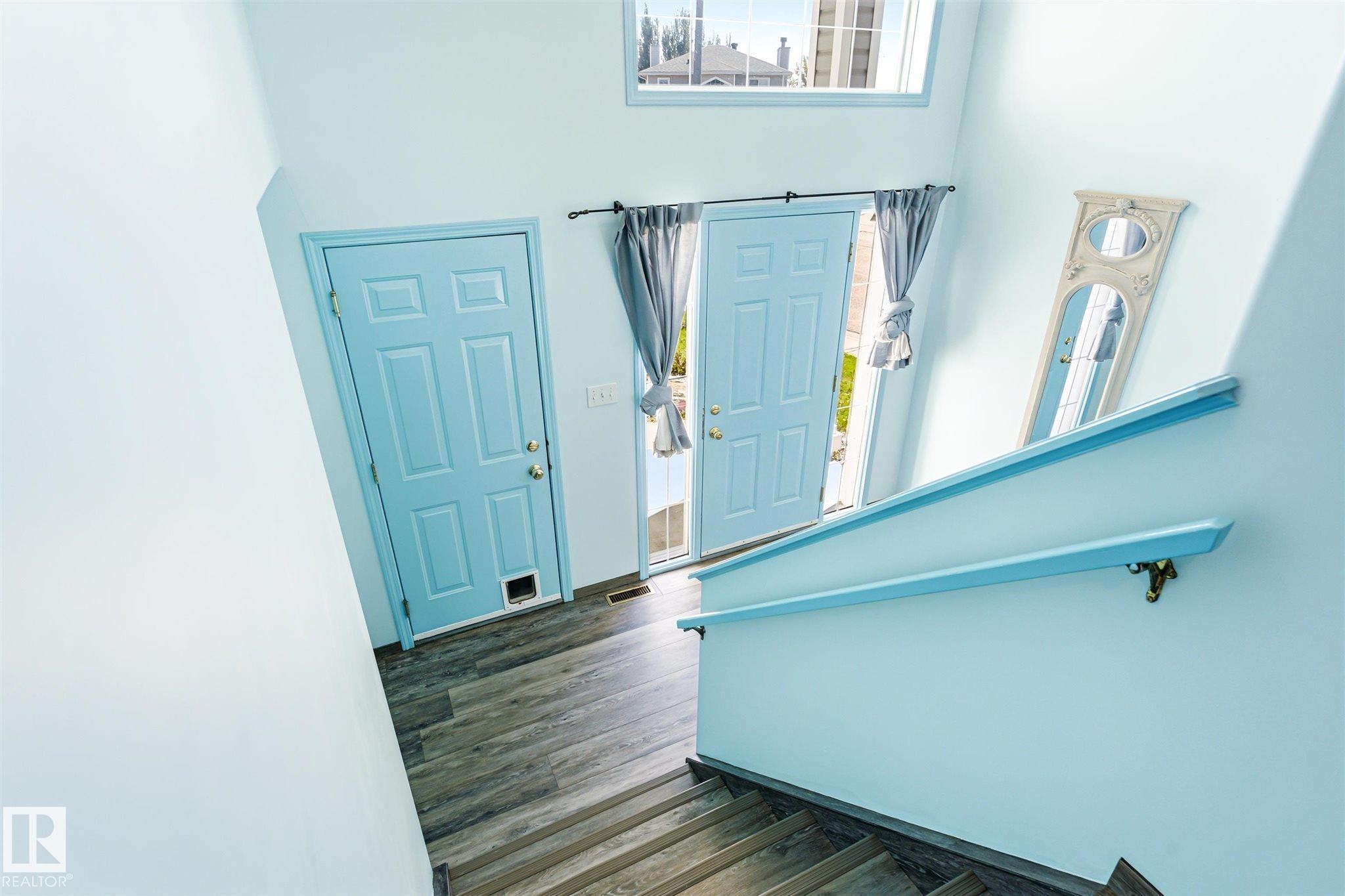 Entryway with two paneled doors, one featuring a pet door - 14908 137 Street Nw, Edmonton, AB - Indoor Photo Showing Other Room