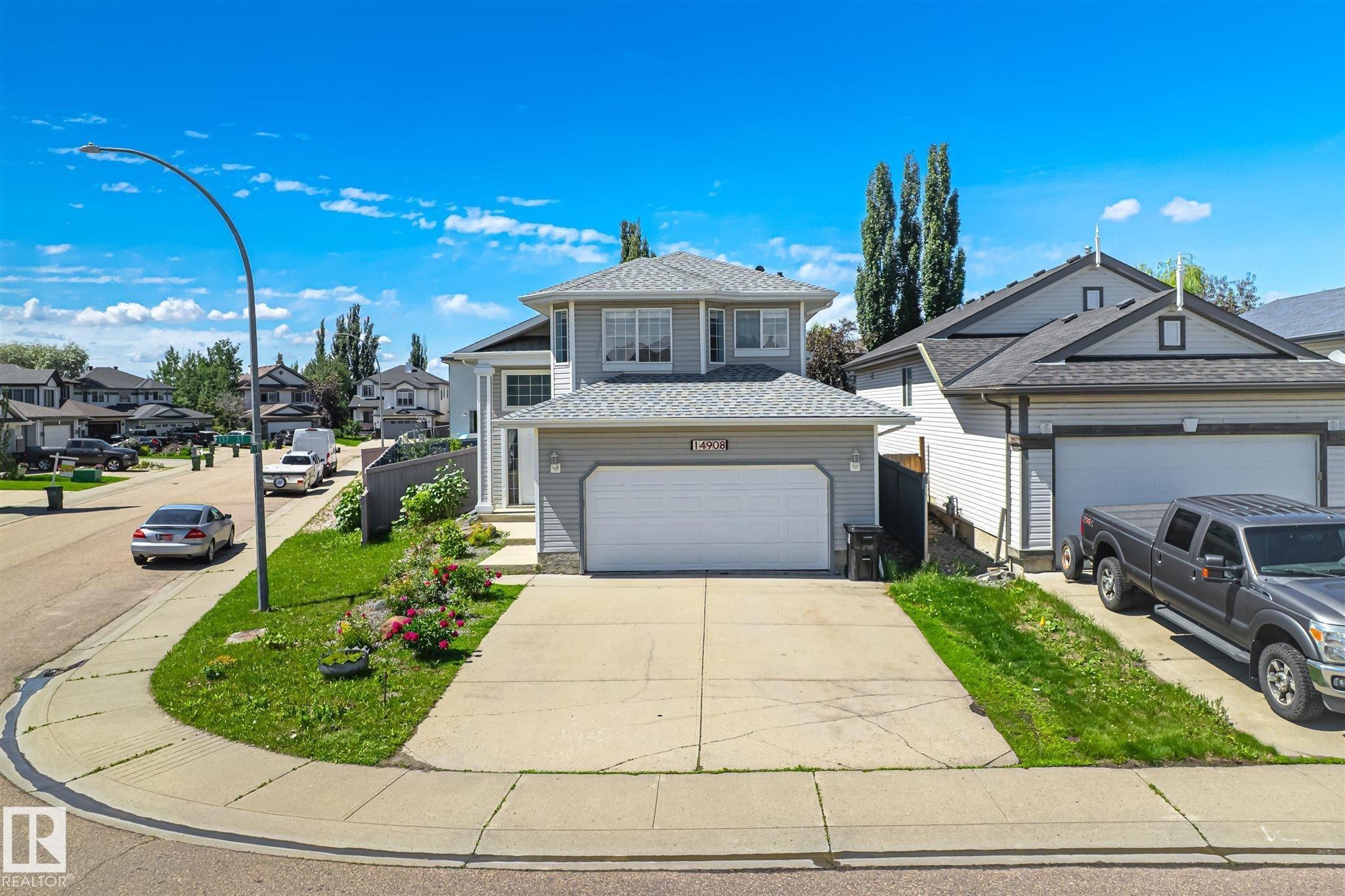 Two-story residence with light gray siding and a front-facing attached two-car garage - 14908 137 Street Nw, Edmonton, AB - Outdoor With Facade