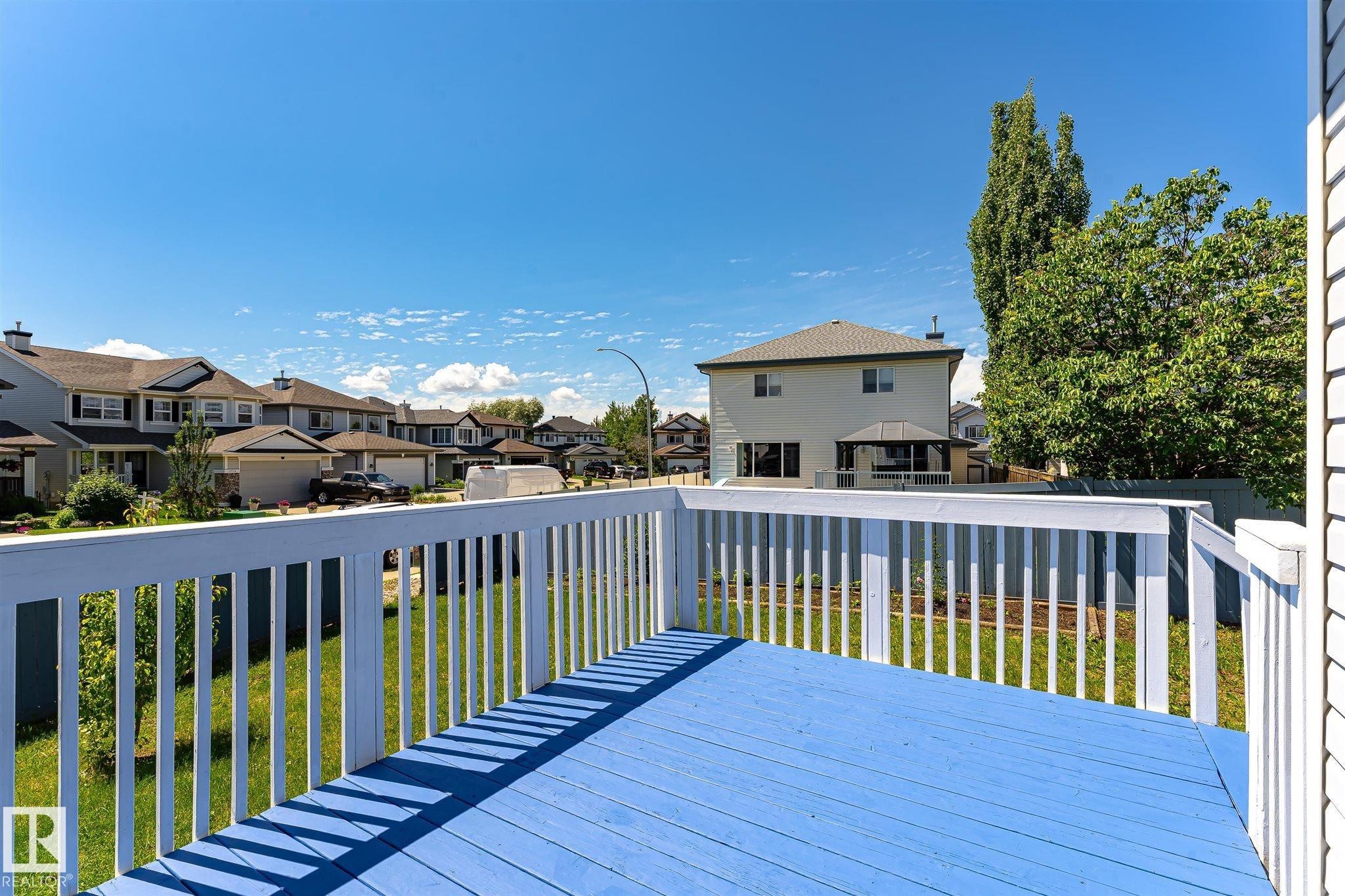 Blue painted deck surface with white railing - 14908 137 Street Nw, Edmonton, AB - Outdoor With Deck Patio Veranda With Exterior