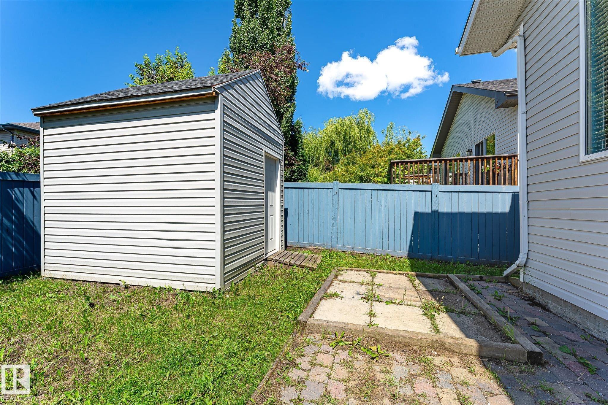 Outdoor storage shed with horizontal siding and a single entry door - 14908 137 Street Nw, Edmonton, AB - Outdoor With Exterior