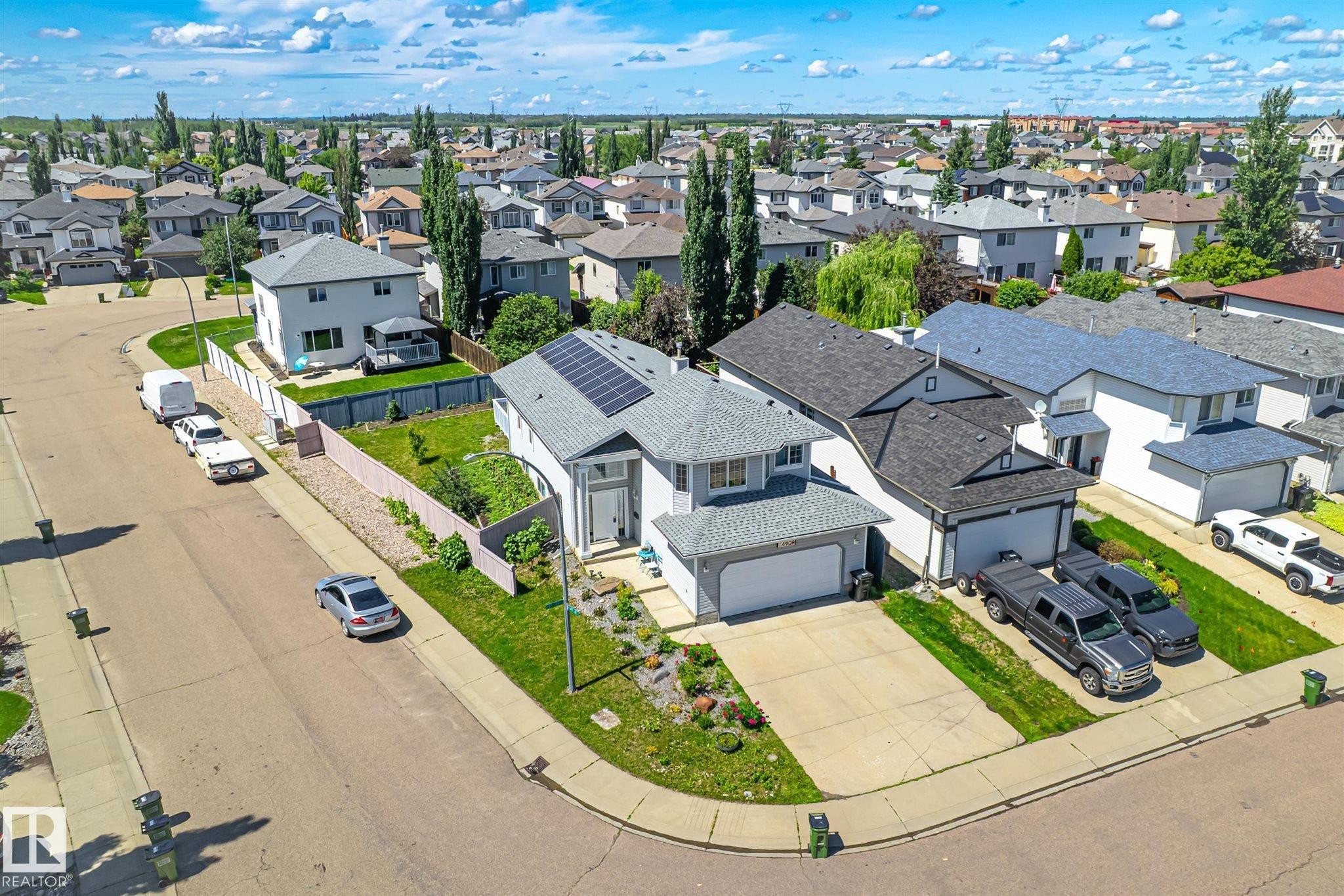 Contemporary two-story residence featuring an attached garage and a concrete driveway - 14908 137 Street Nw, Edmonton, AB - Outdoor With View