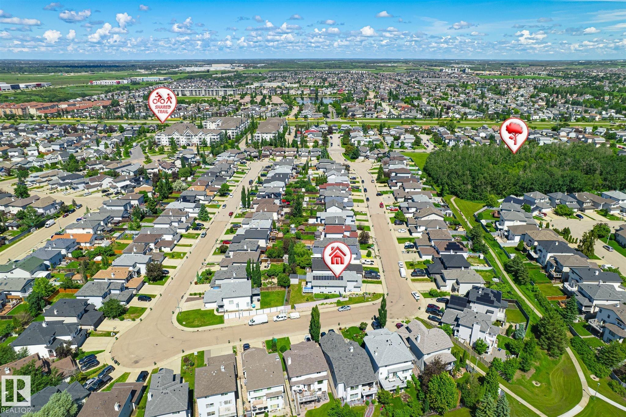 Aerial perspective showcasing a residential area with a prominent central street and numerous single-family homes - 14908 137 Street Nw, Edmonton, AB - Outdoor With View