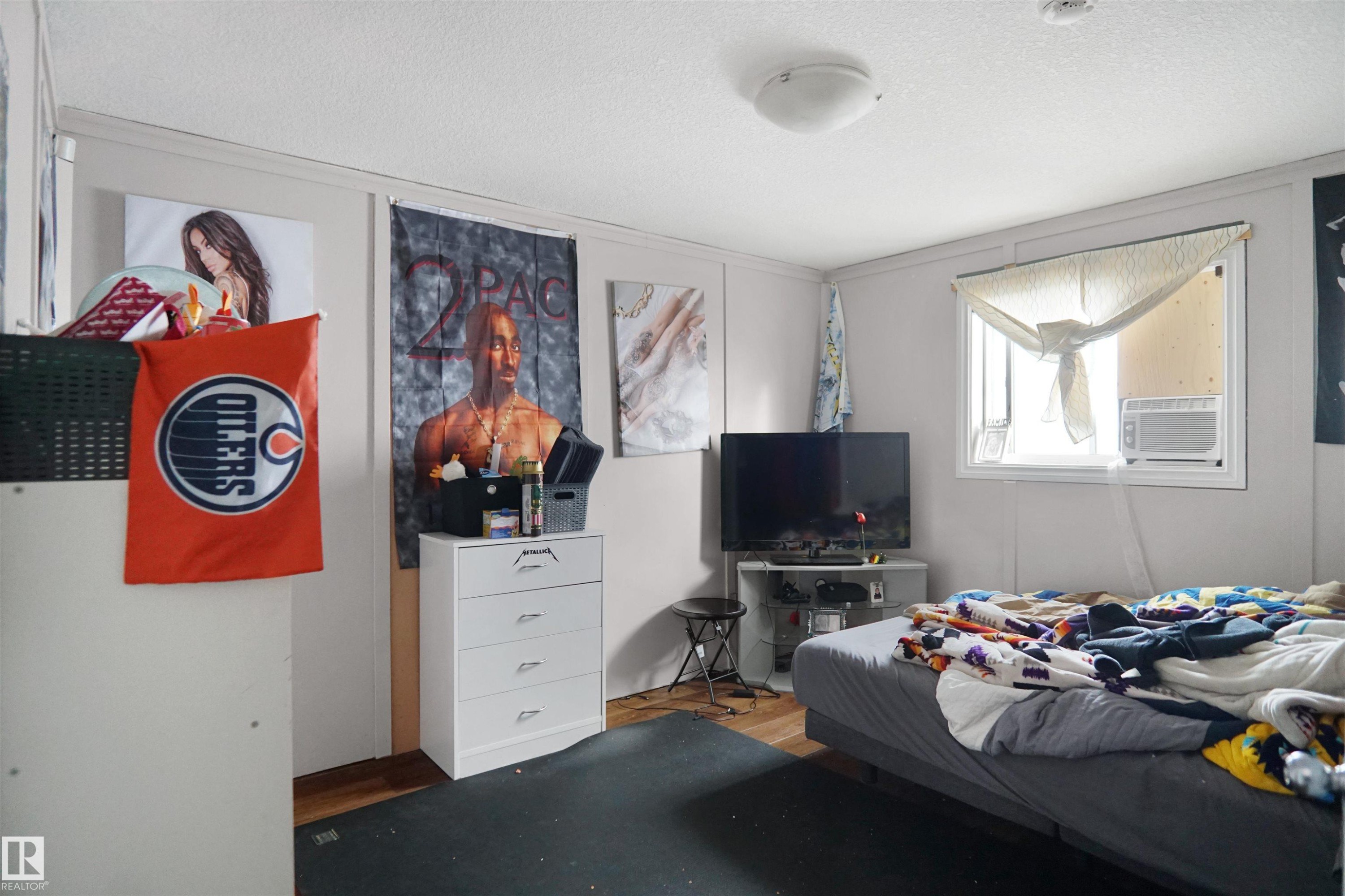 Bedroom with wood-finish flooring and a white ceiling - 4816 155 Ave, Edmonton, AB