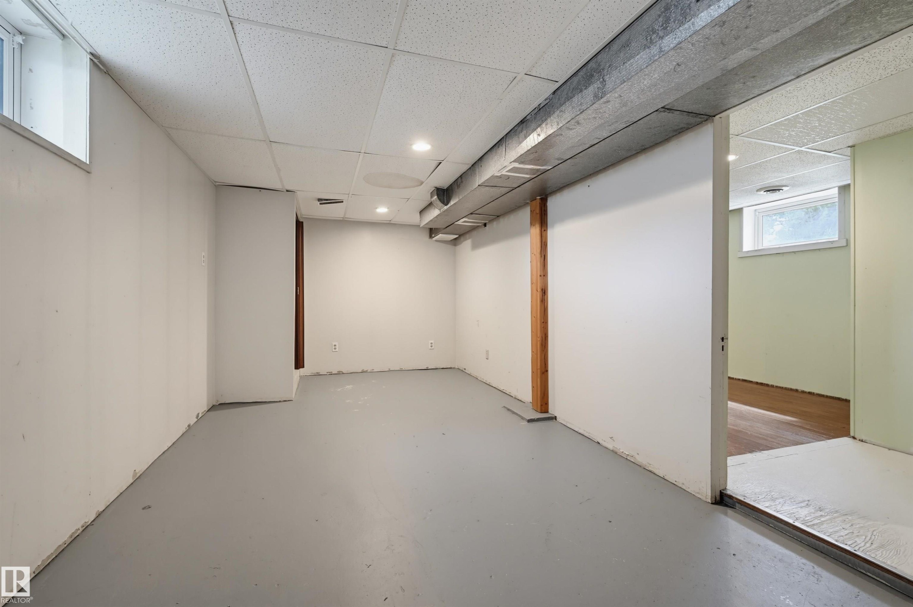Spacious lower level offering painted concrete flooring, recessed lighting, and a drop ceiling - 11450 71 Street Nw, Edmonton, AB