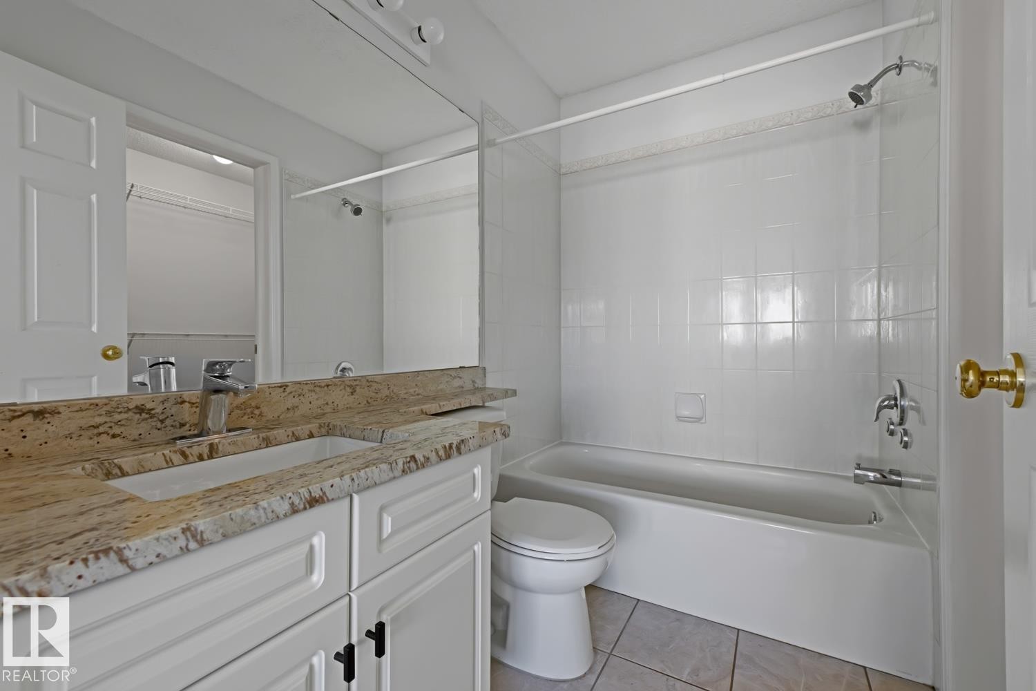 Bathroom featuring a white vanity with a granite countertop, a single basin sink, and a chrome faucet - 6 1237 Carter Crest Road, Edmonton, AB