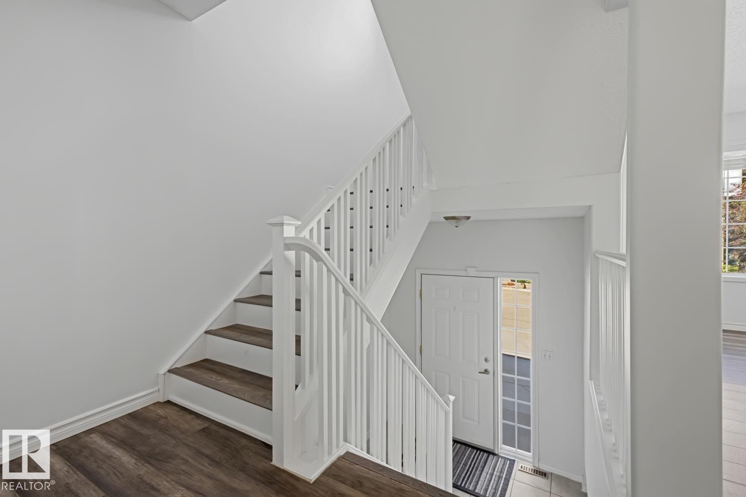 Staircase entry featuring wood-finish treads and white risers - 6 1237 Carter Crest Road, Edmonton, AB