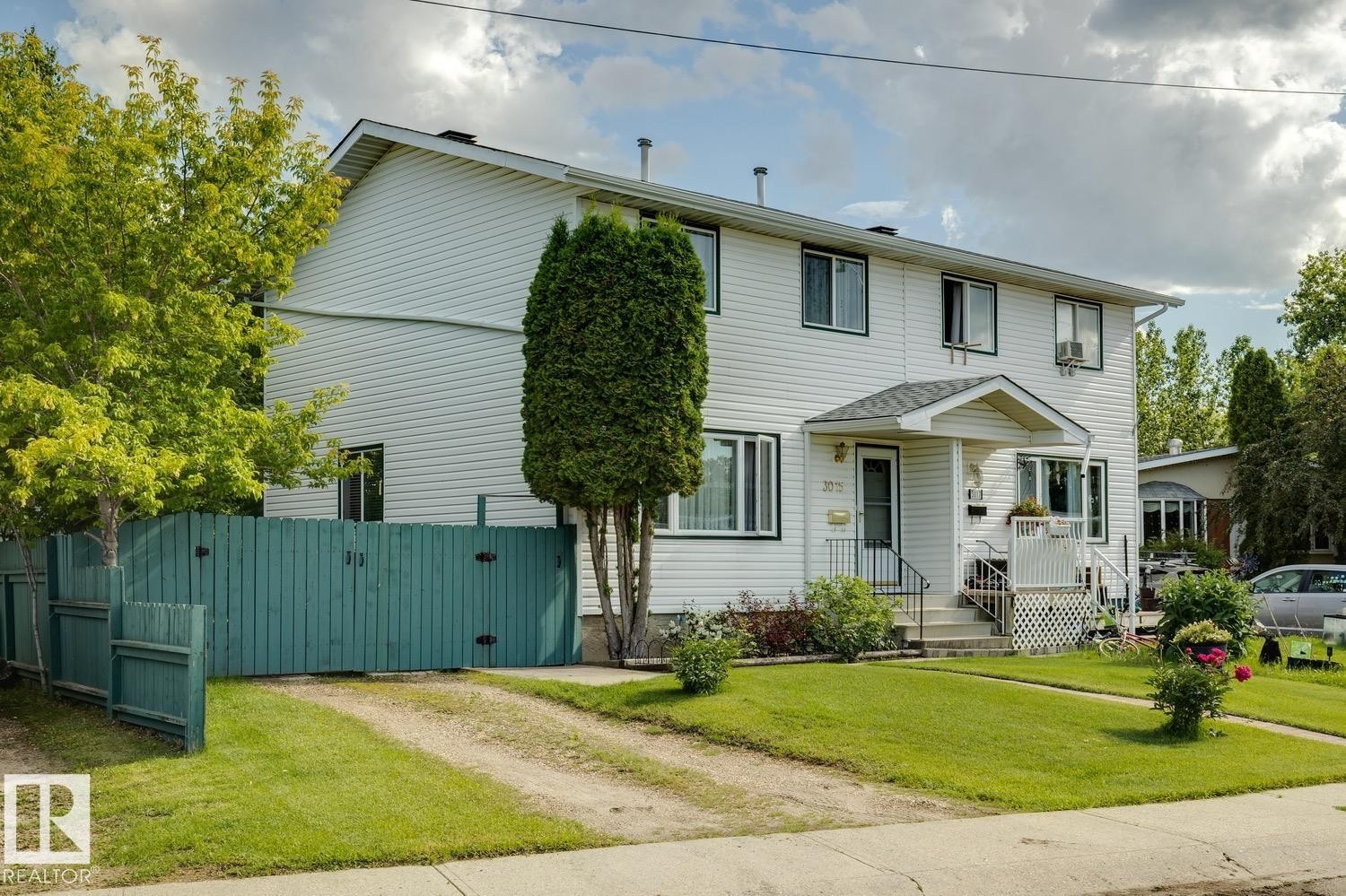 Two-story duplex with white siding exterior - 3015 131 Avenue, Edmonton, AB