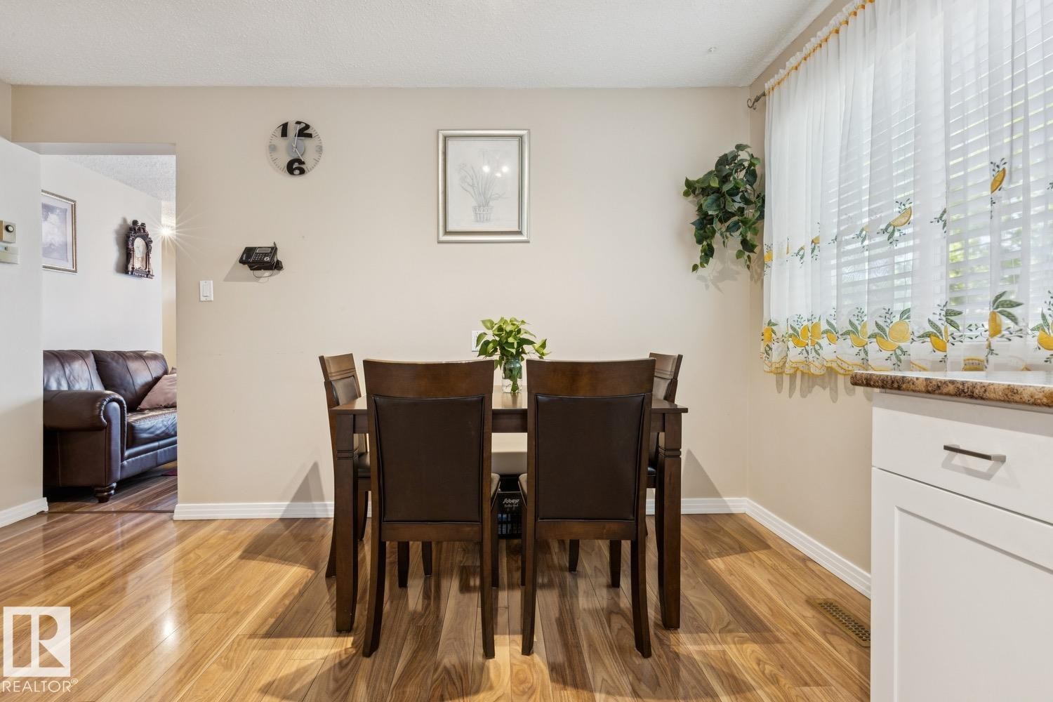Dining area featuring wood-finish flooring, neutral wall paint, and white baseboards - 3015 131 Avenue, Edmonton, AB
