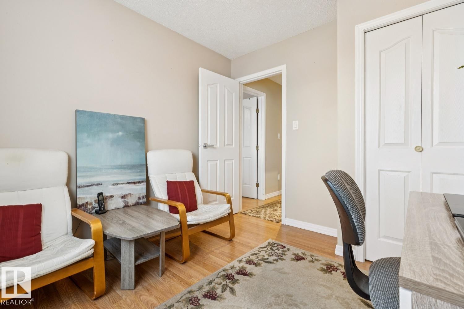 This room features light-toned walls, wood-finish flooring, and white trim - 3015 131 Avenue, Edmonton, AB