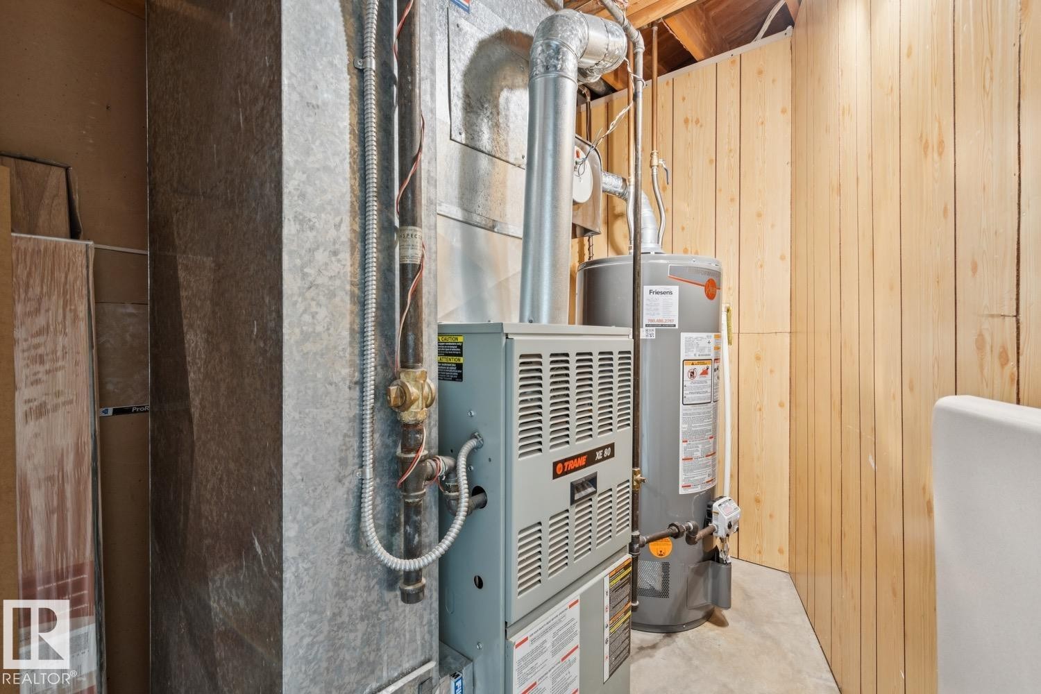Utility area featuring a natural gas furnace, water heater, and exposed ductwork - 3015 131 Avenue, Edmonton, AB