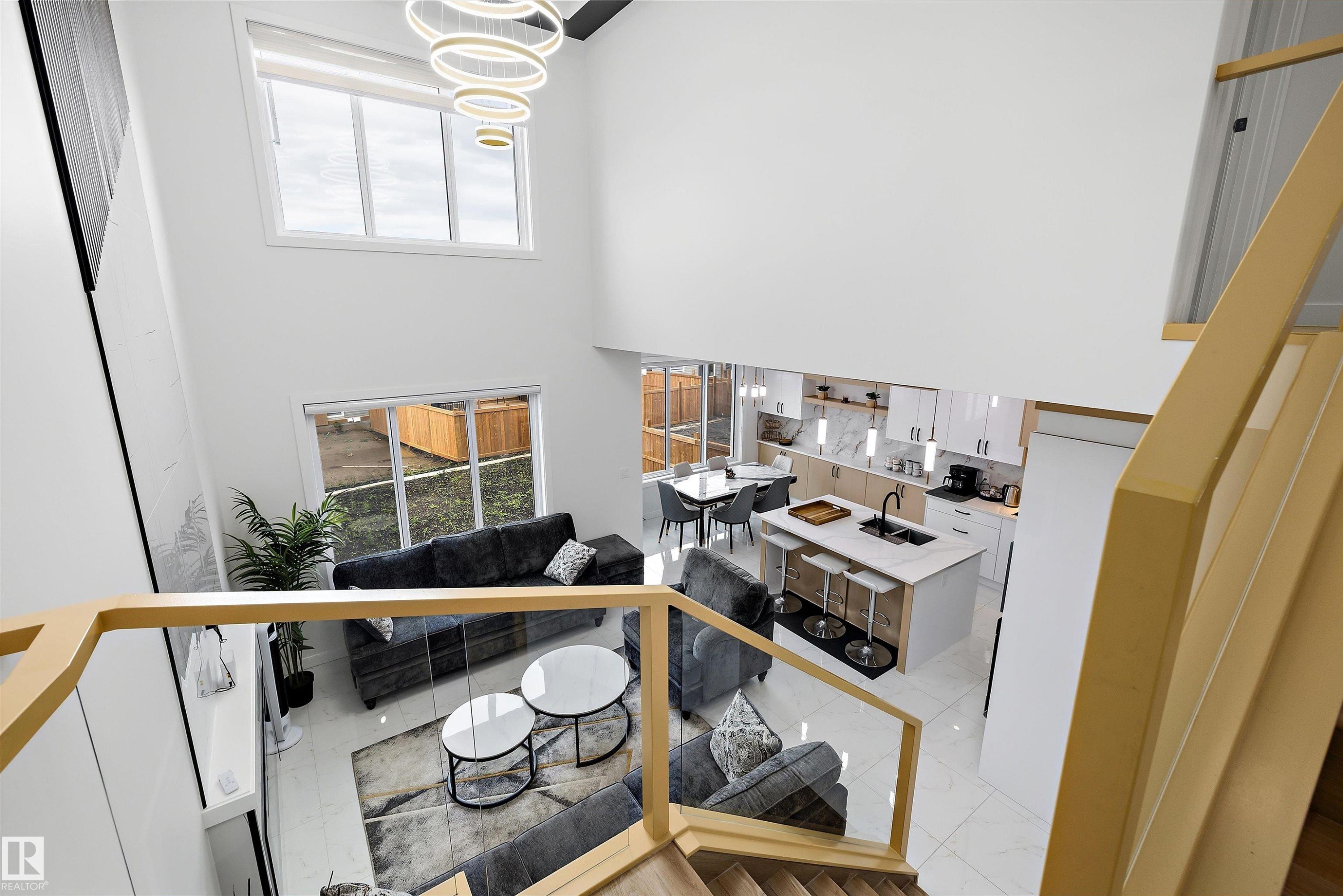 Spacious open-concept living area featuring high ceilings and abundant natural light - 403 Pine Point, Leduc, AB