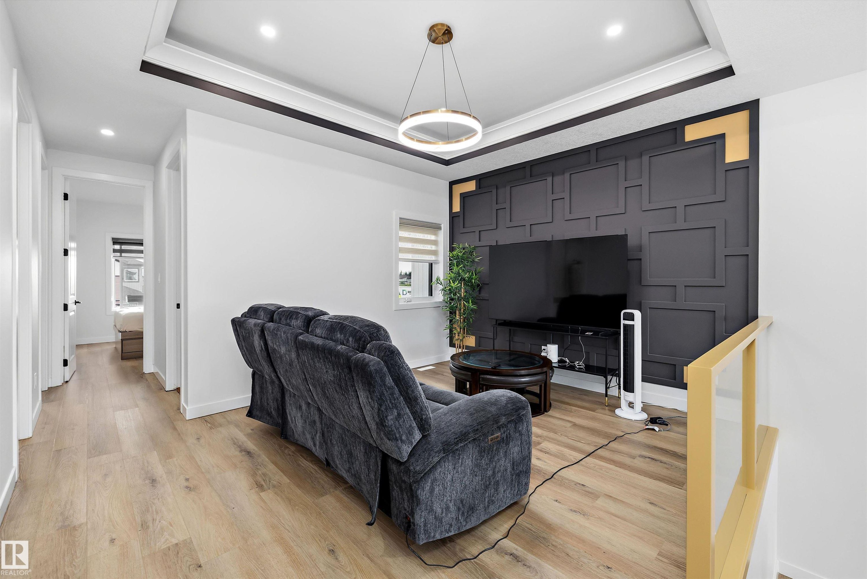 Accent wall featuring geometric paneling and gold-tone corner details - 403 Pine Point, Leduc, AB
