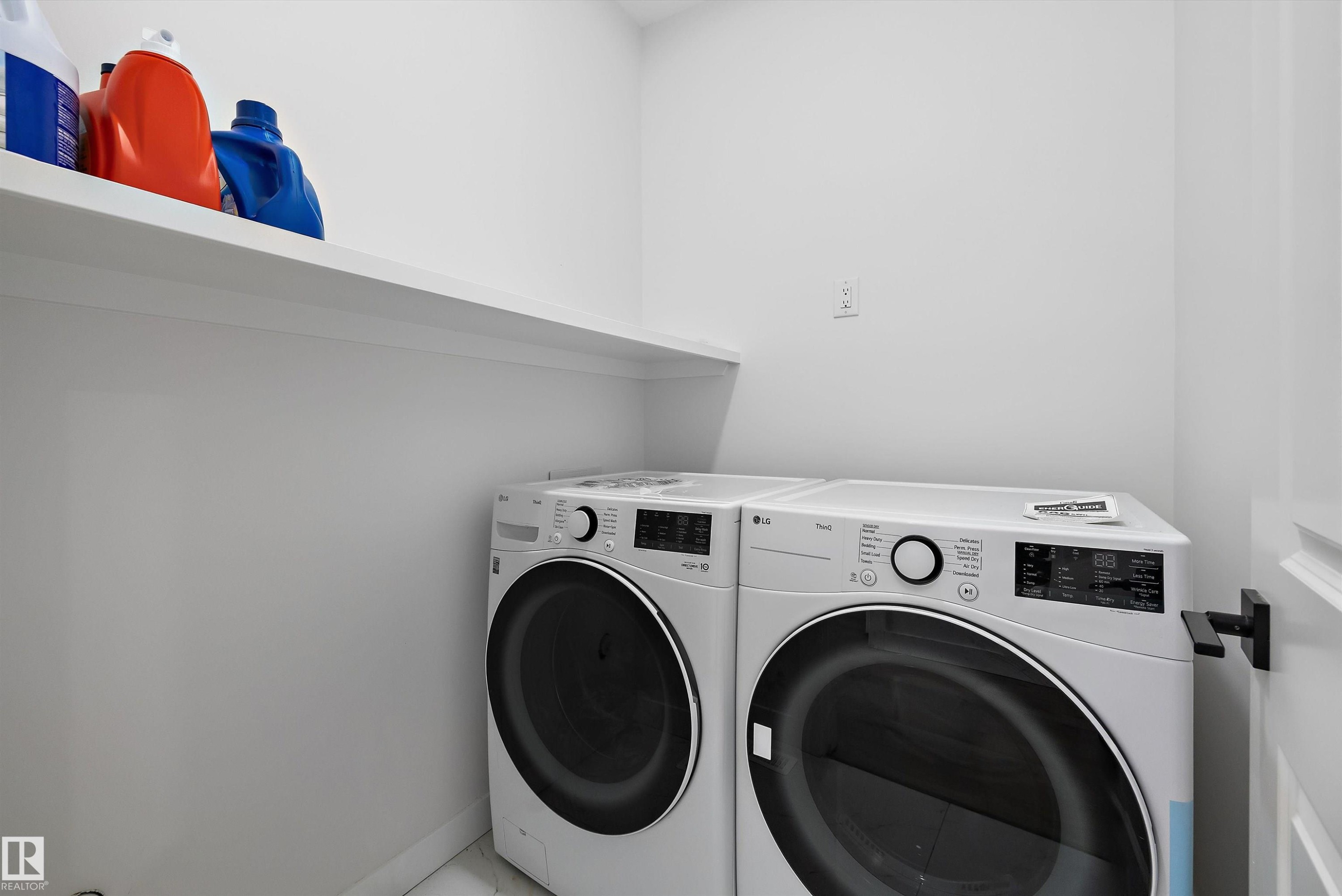 Dedicated laundry space featuring a white built-in shelf and light-colored walls - 403 Pine Point, Leduc, AB