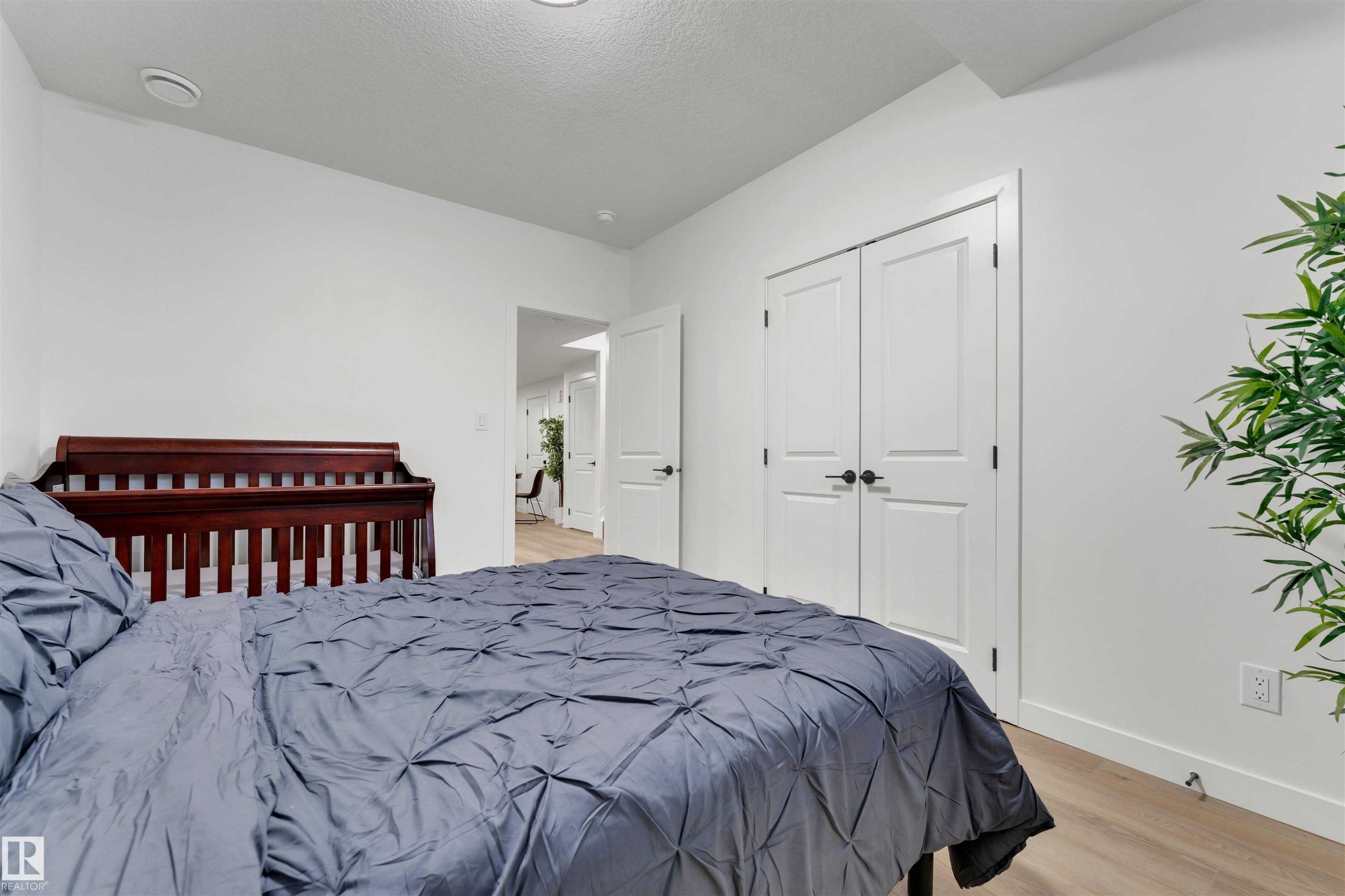 Interior room featuring light wood-finish flooring and white baseboards - 403 Pine Point, Leduc, AB