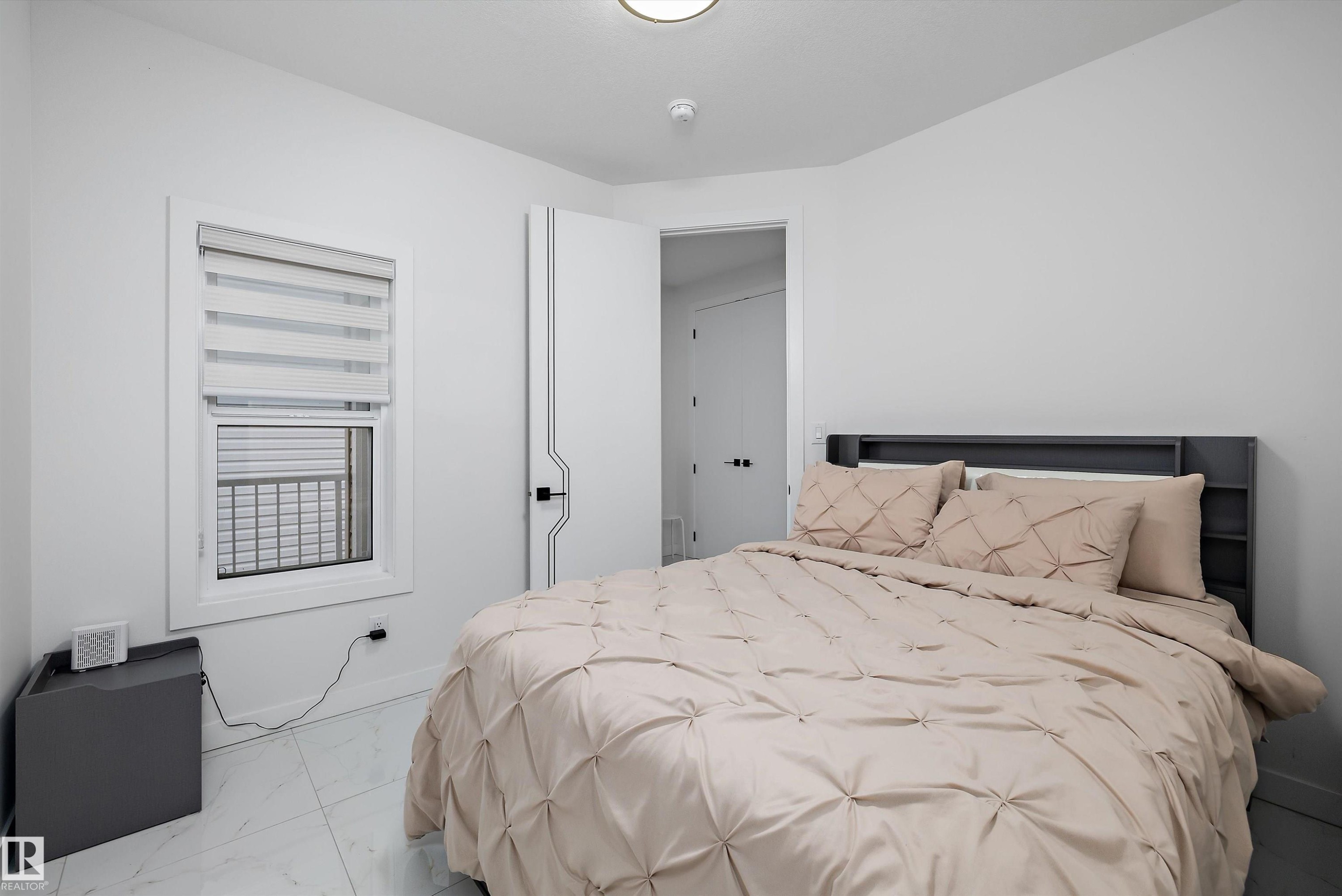 Bright room featuring white walls and white tile flooring - 403 Pine Point, Leduc, AB