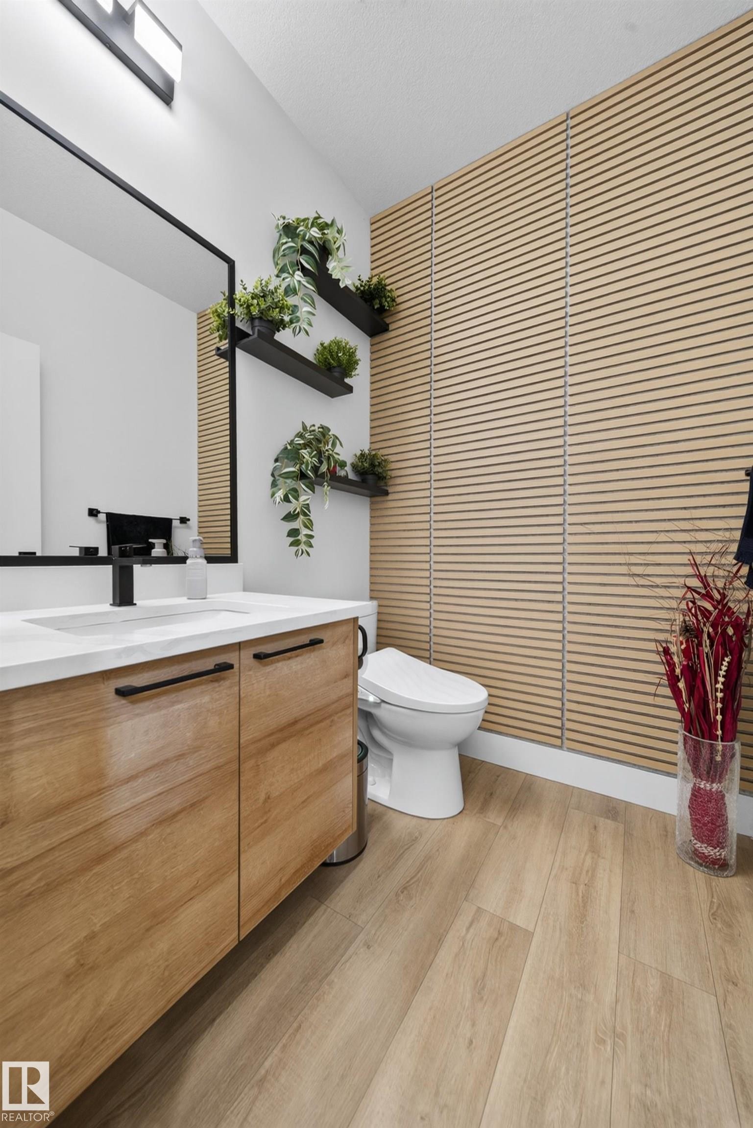Contemporary bathroom featuring a wood-finish vanity with a white countertop and matte black hardware - 626 Astoria Way, Devon, AB