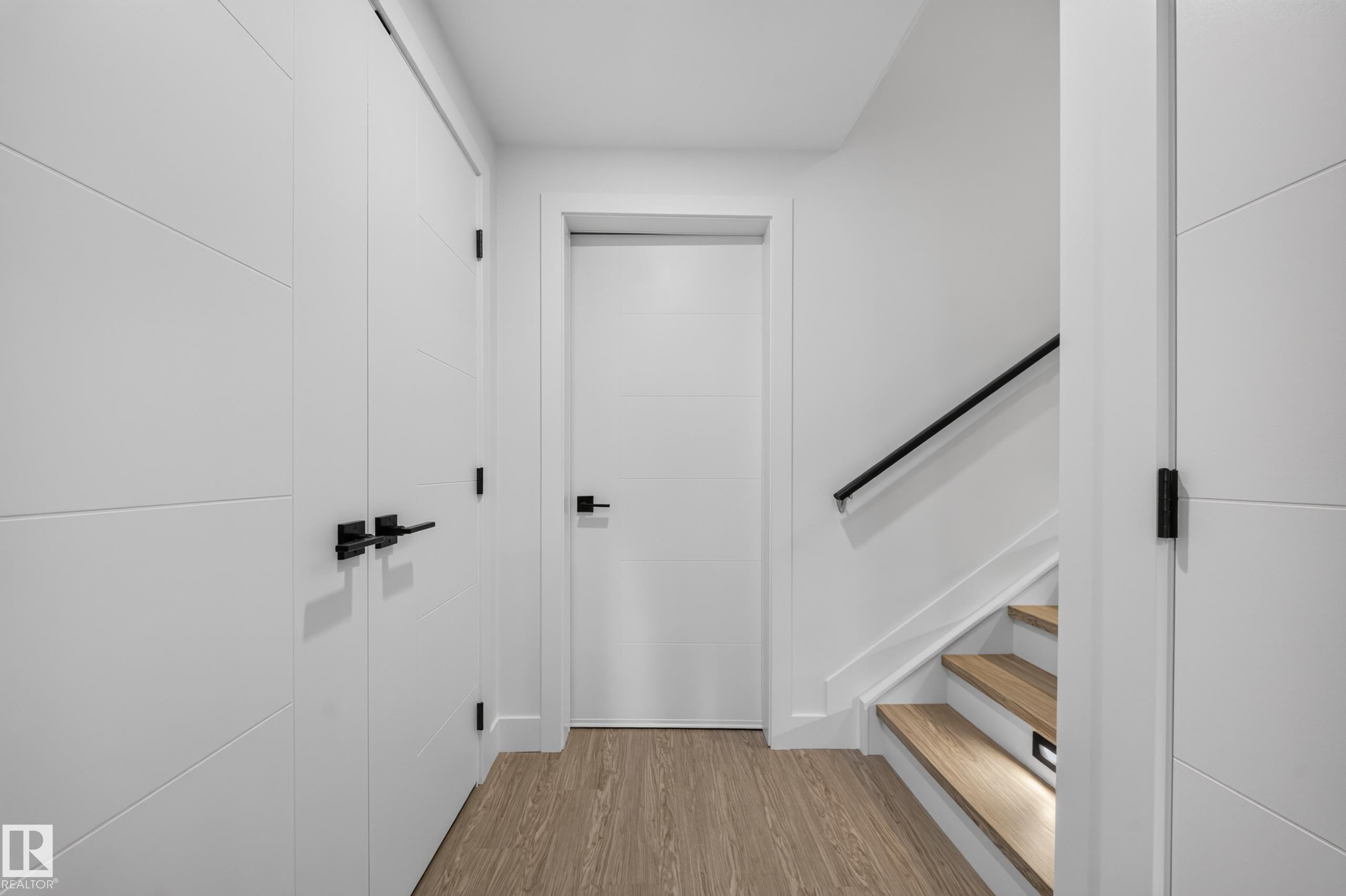 Contemporary entryway featuring light wood-finish flooring and crisp white walls - 626 Astoria Way, Devon, AB